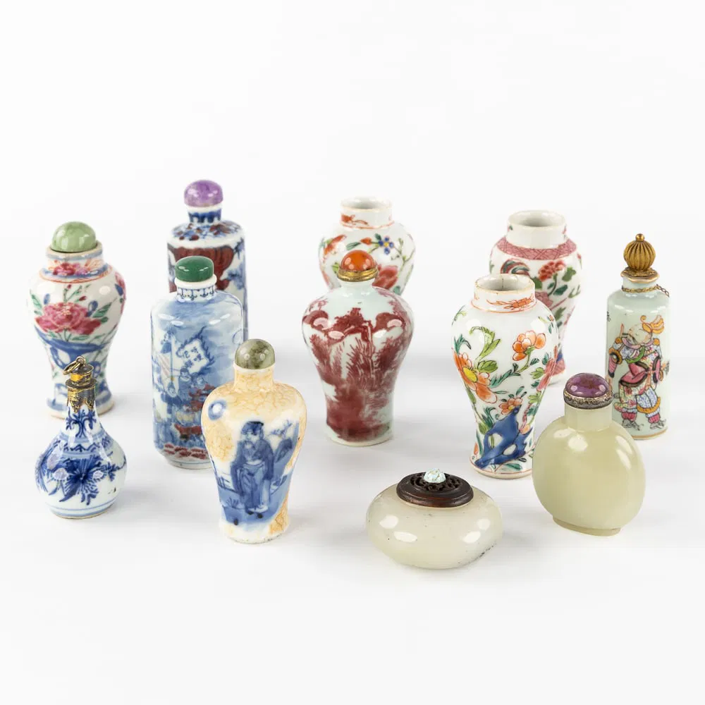 A Collection of 12 Chinese snuff and opium bottles, porcelain, jade, and natural stone, 18th, 19th