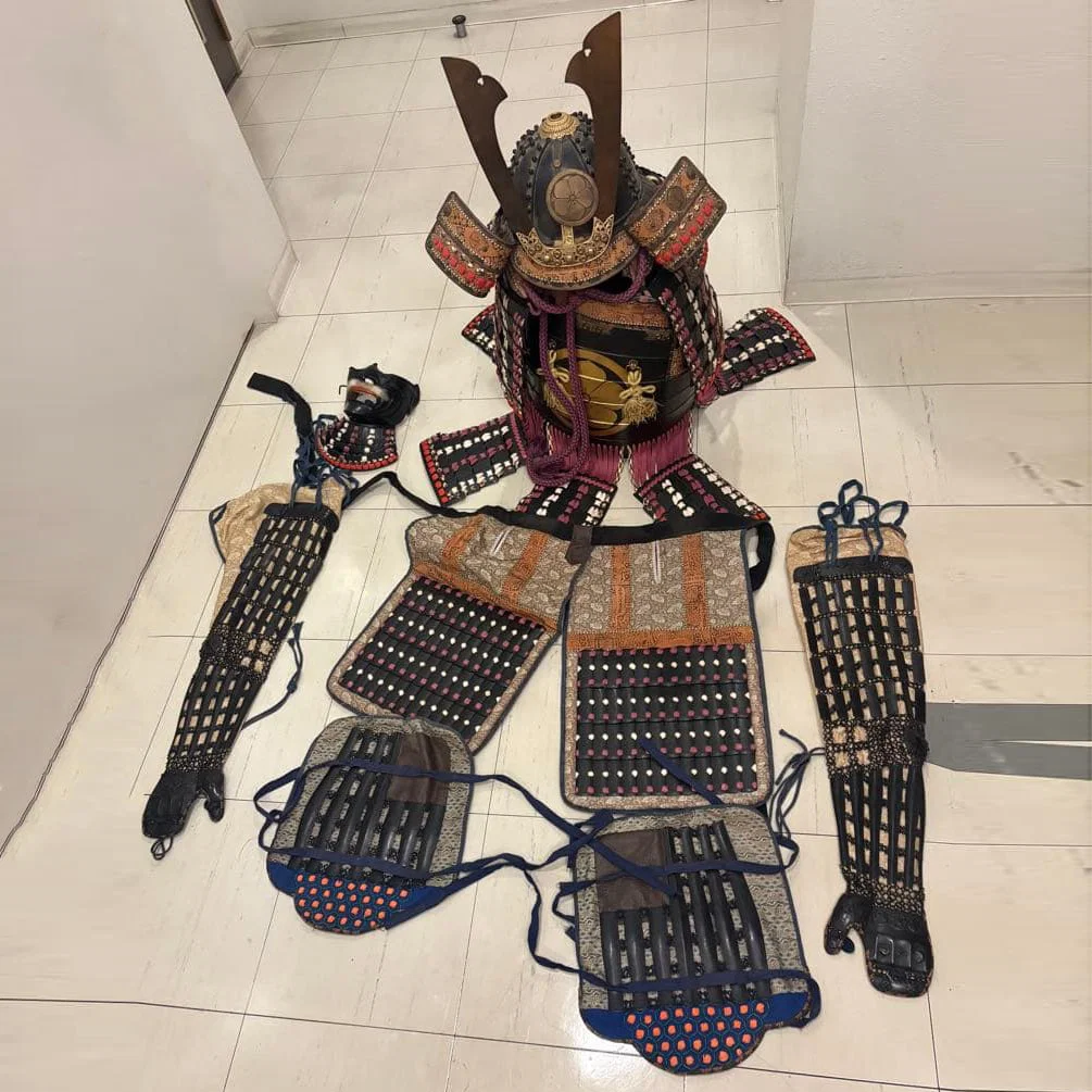 A complete set of samurai armor, replica swords, and battle surcoat.