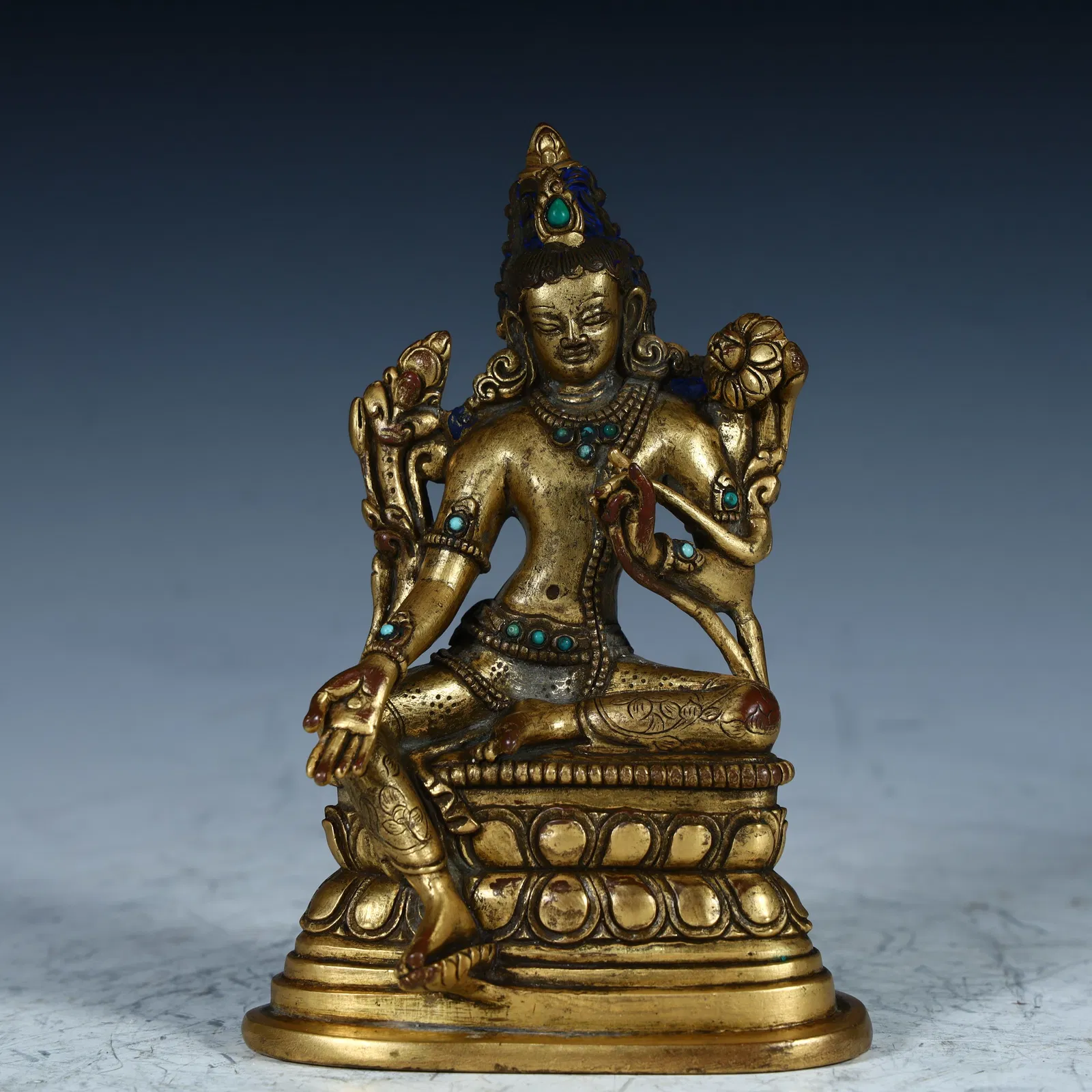A copper-gilt green Tara Buddha statue from the Qing Dynasty