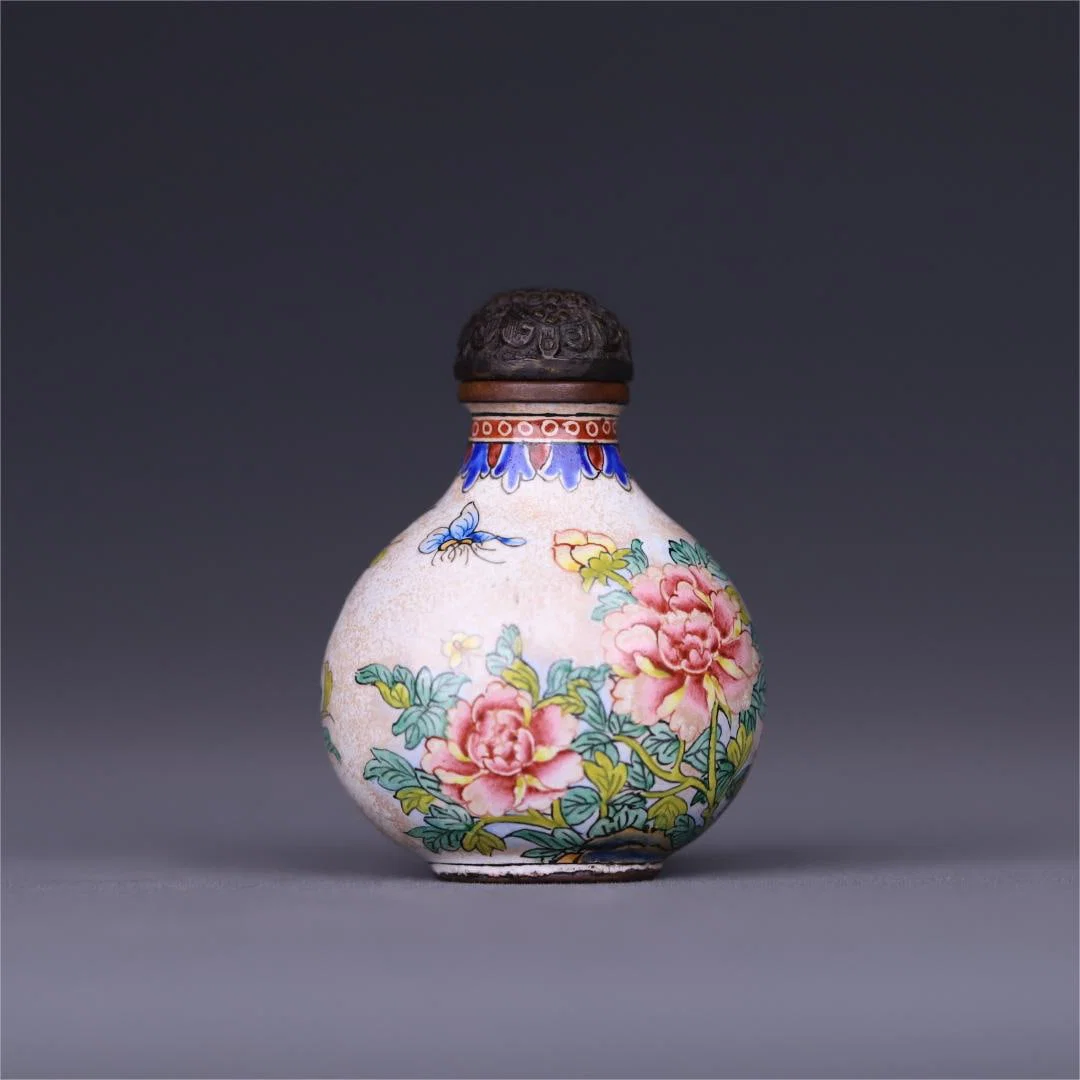 A copper-tired enamel flower and bird pattern snuff bottle made in the Qianlong period of the Qing