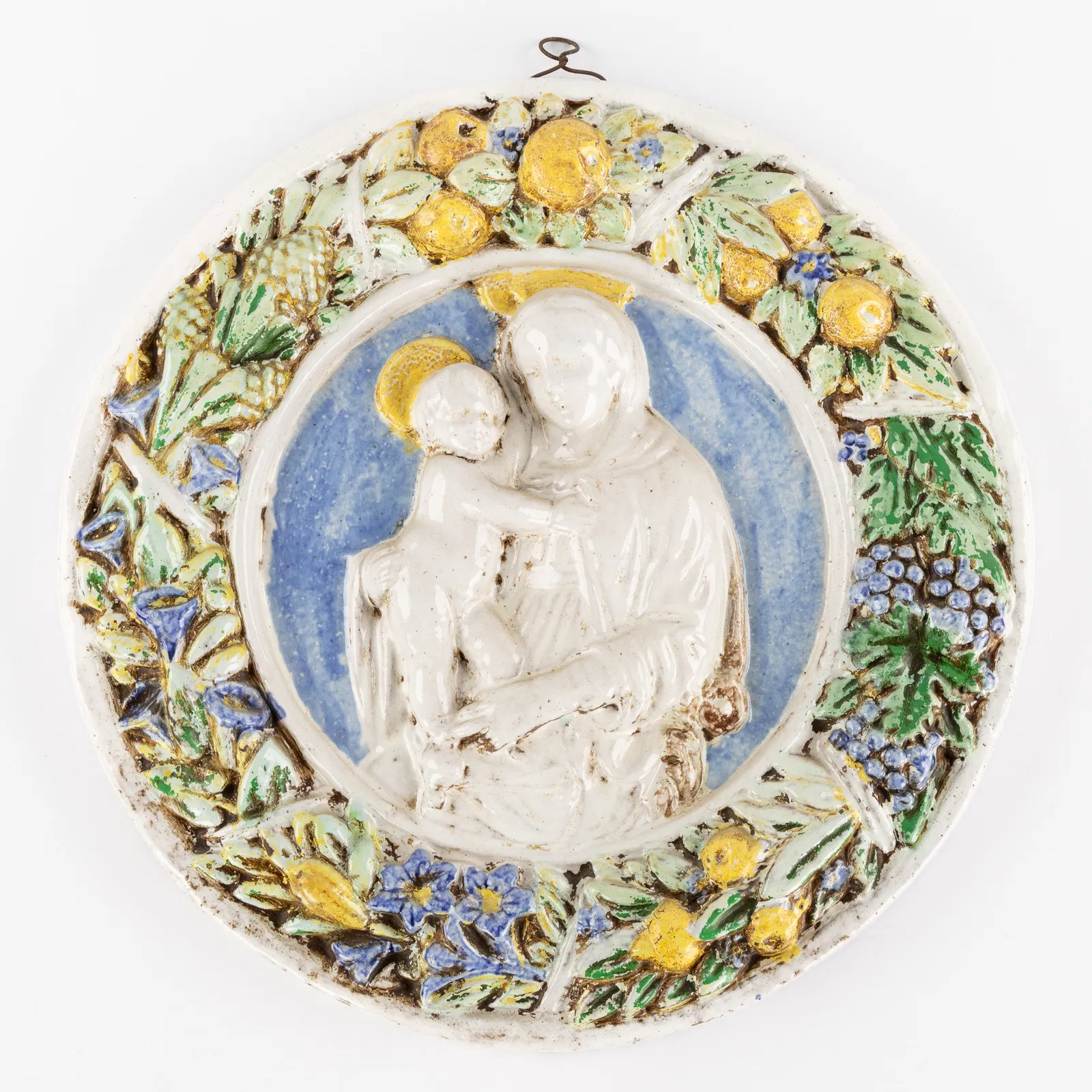 A Decorative tondo or bas-relief, 'Madonna and Child', glazed terracotta, in the style of Luca della