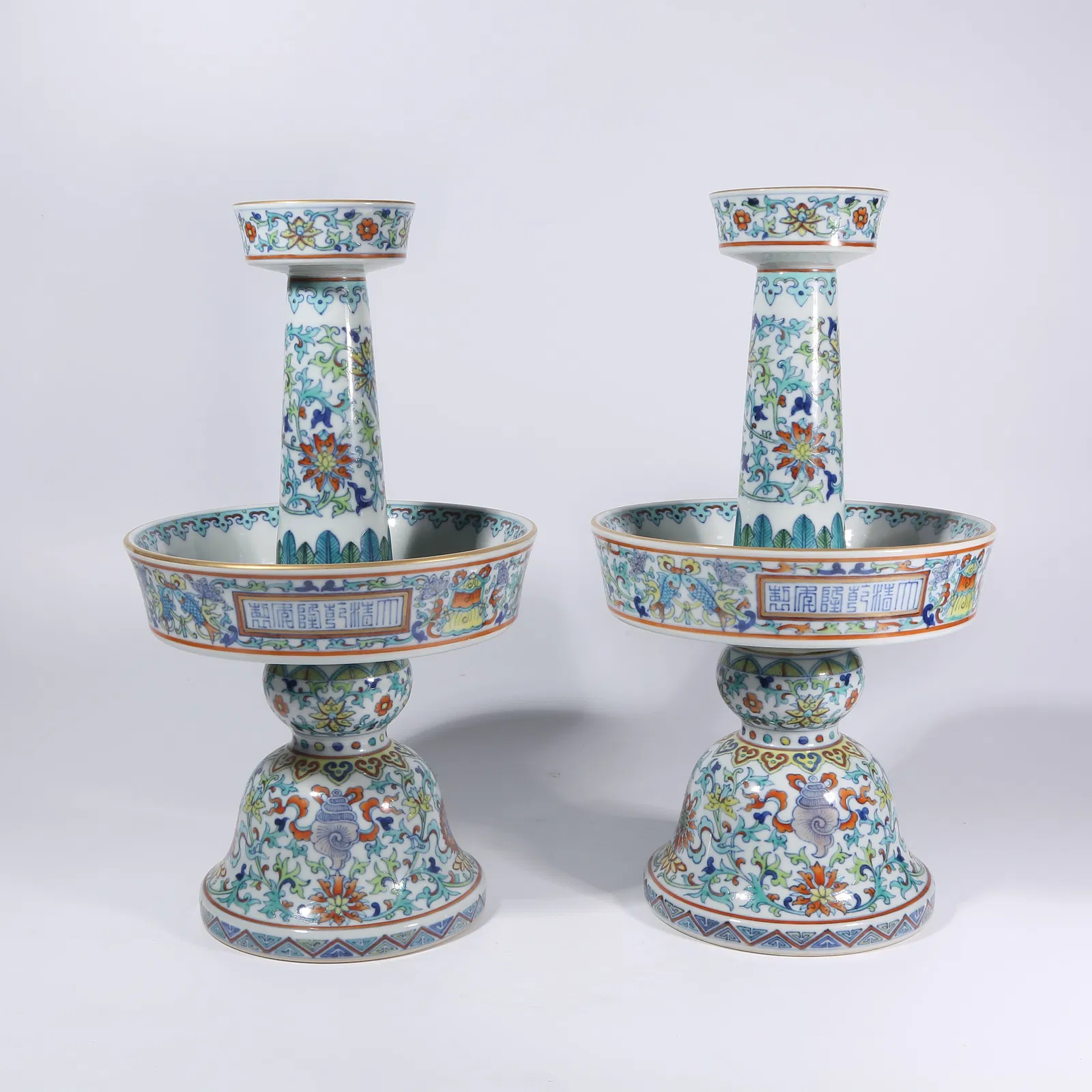 A DOUCAI PASSIONFLOWER WITH EIGHT AUSPICIOUS SYMBOLS CANDLESTICKS, A SET