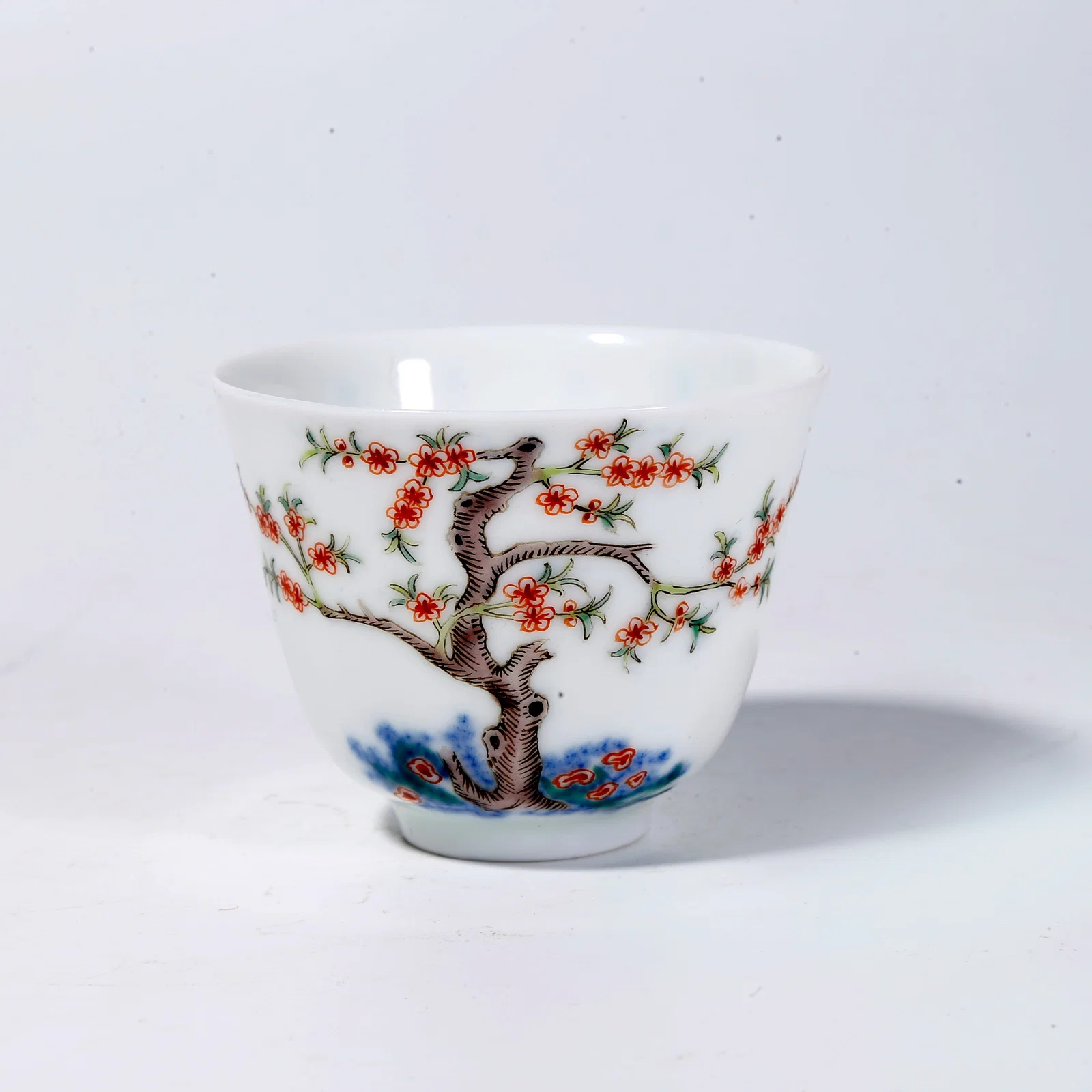 A FAMILLE-ROSE CUP WITH PLUM BLOSSOM MOTIFS