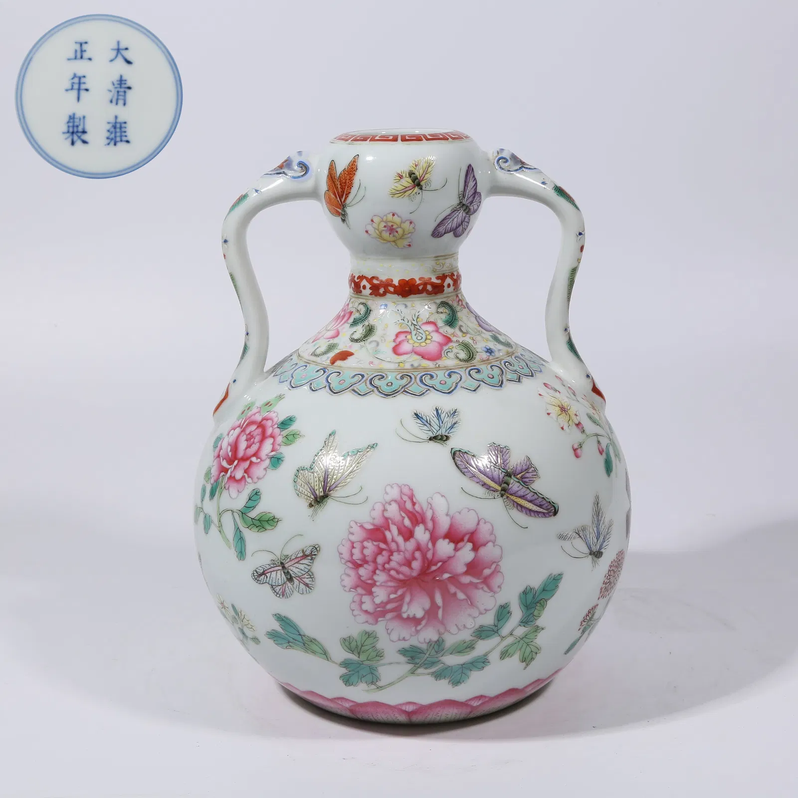 A FAMILLE ROSE FLOWER AND BUTTERFLY RIBBON-HANDLED GOURD VASE