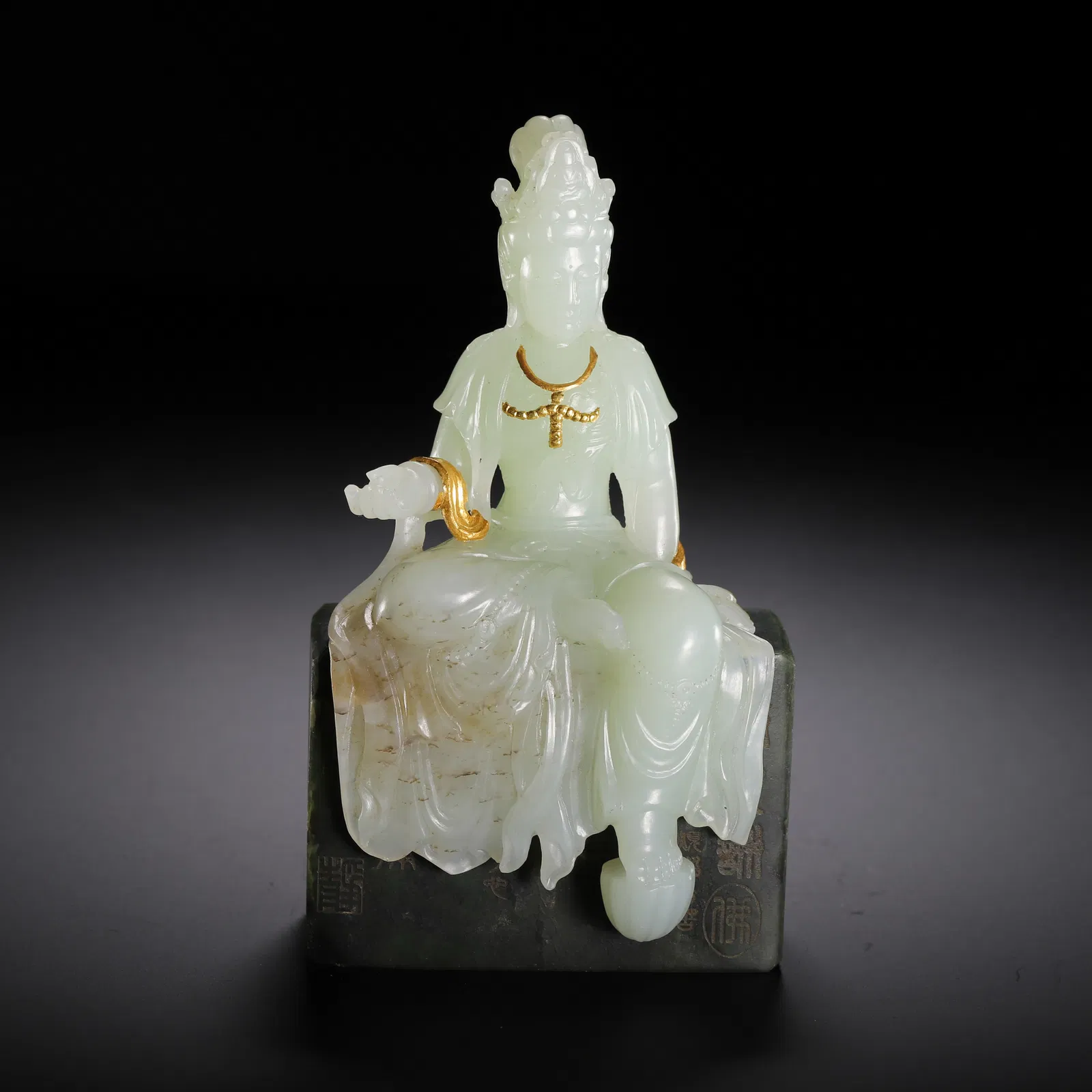 A FINE CARVED JADE SEATED GUANYIN