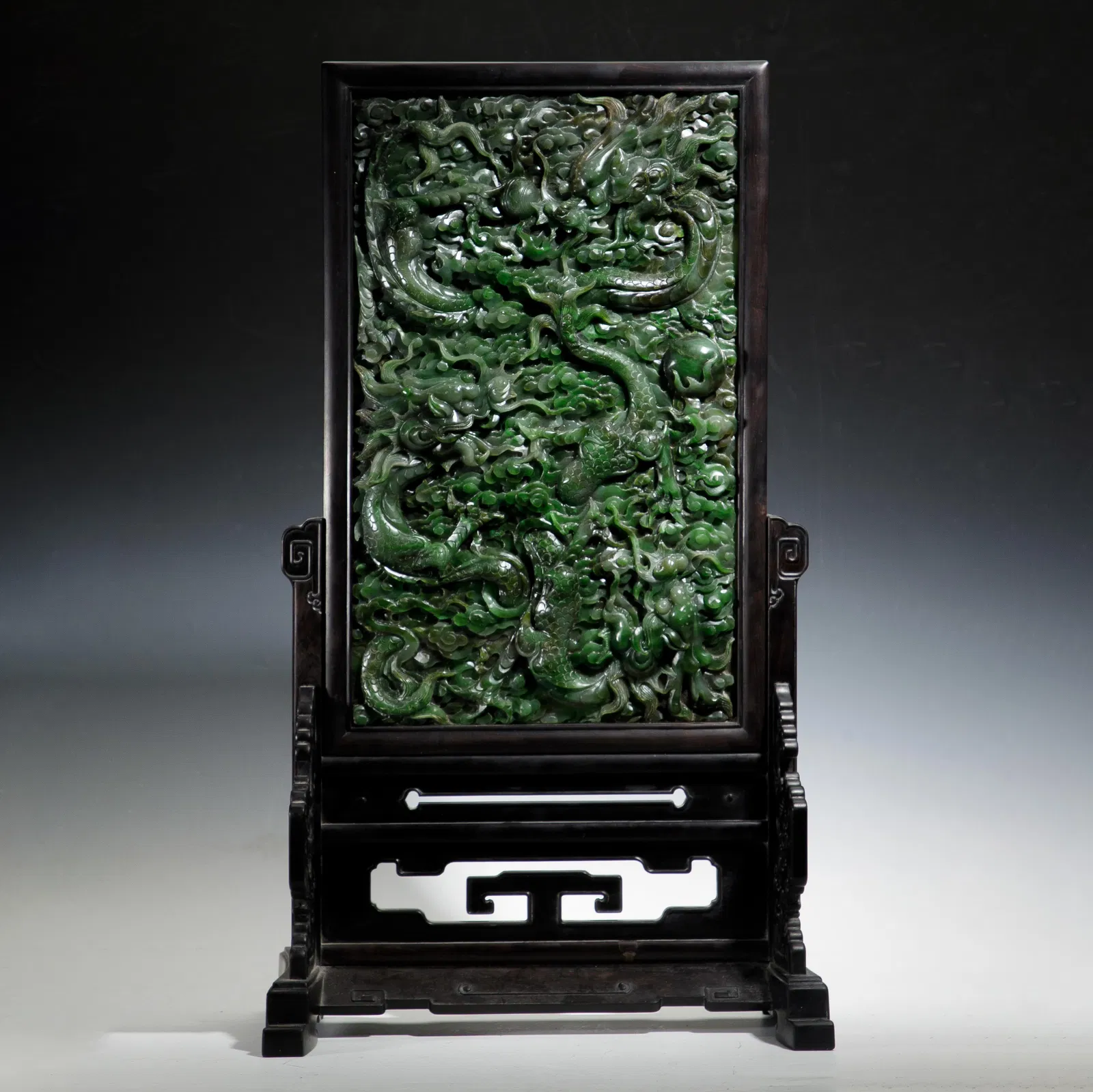 A FINE CARVED SPINACH GREEN JADE DRAGON TABLE SCREEN