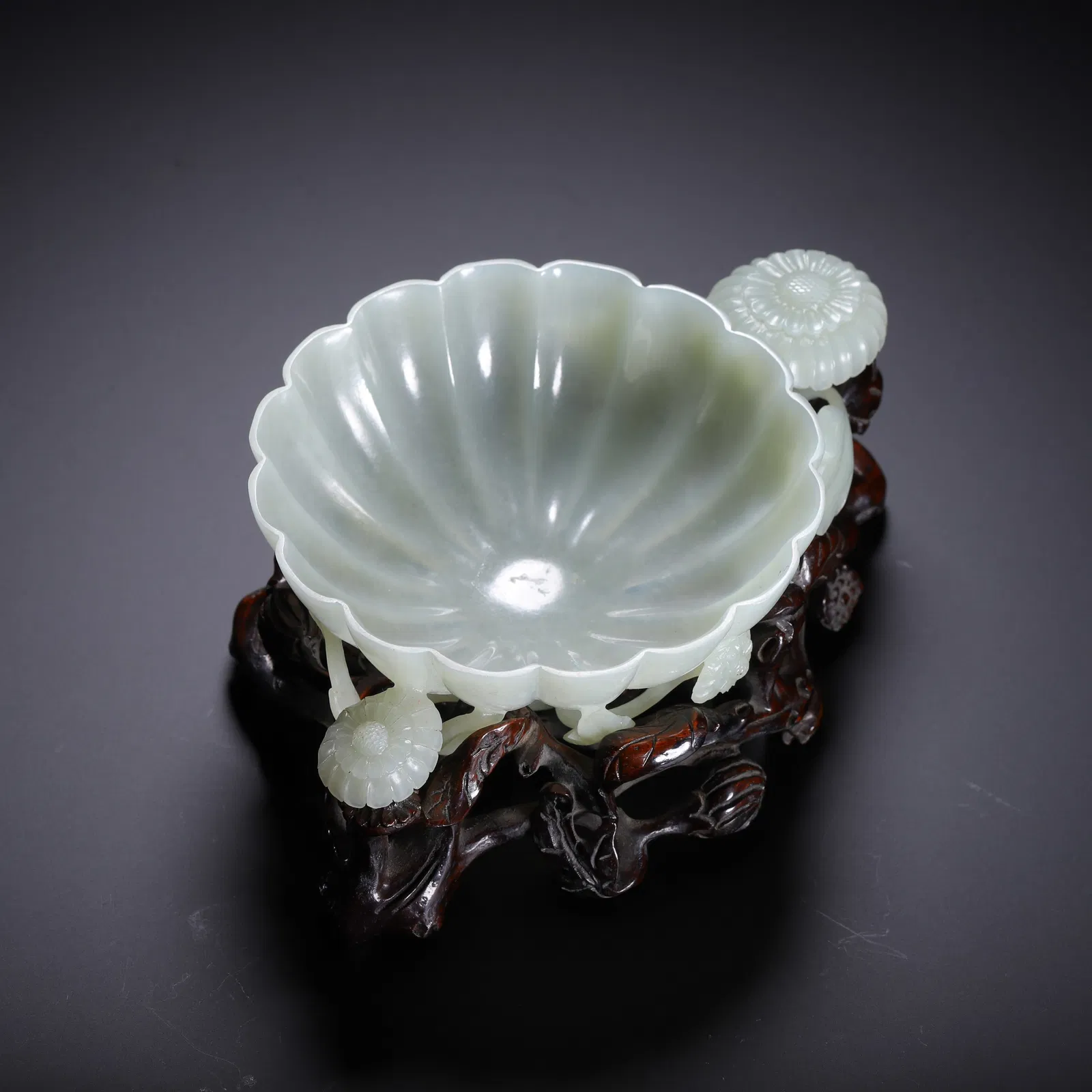A FINE CARVED WHITE JADE LOBED WASHER