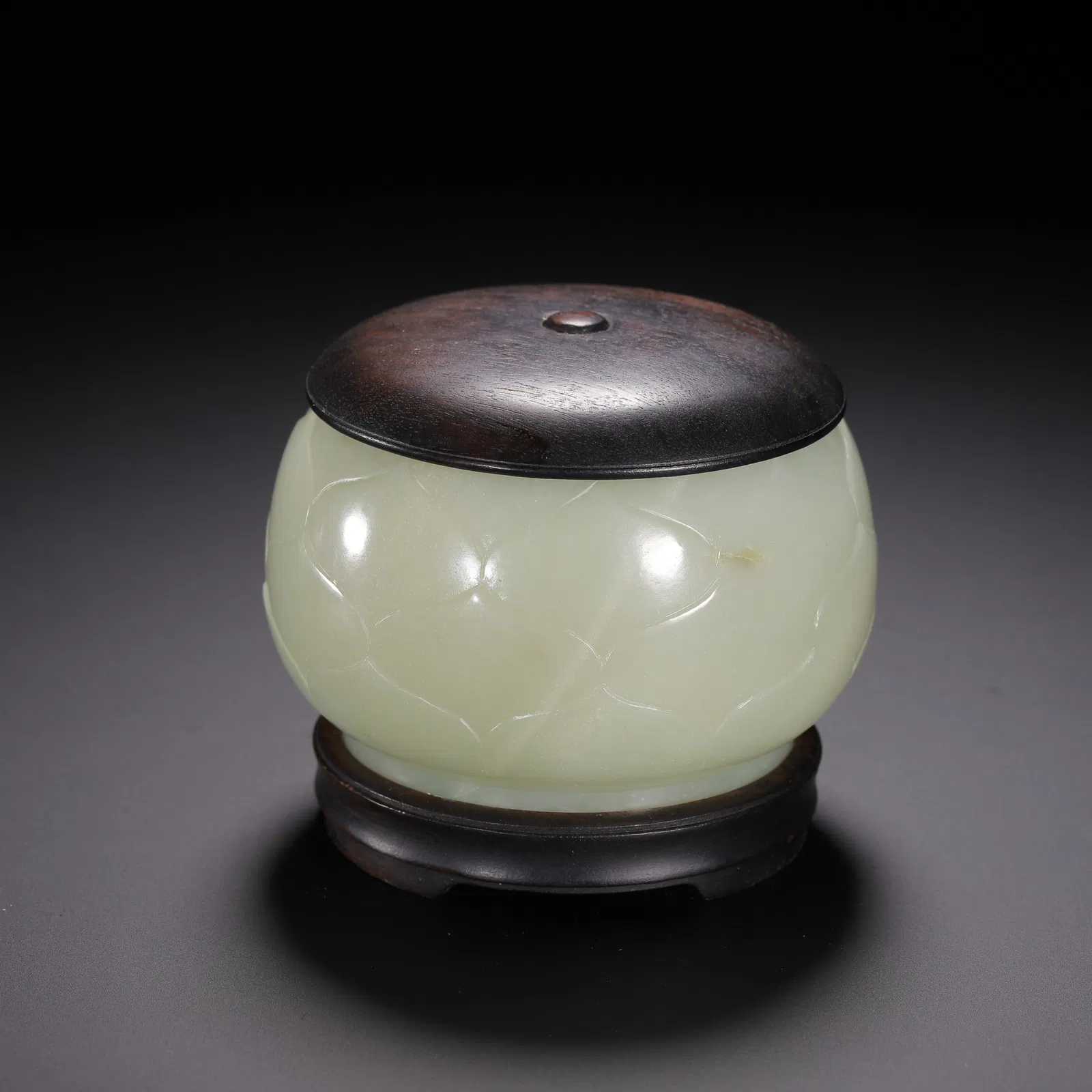 A FINE CARVED WHITE JADE LOTUS JAR WITH COVER