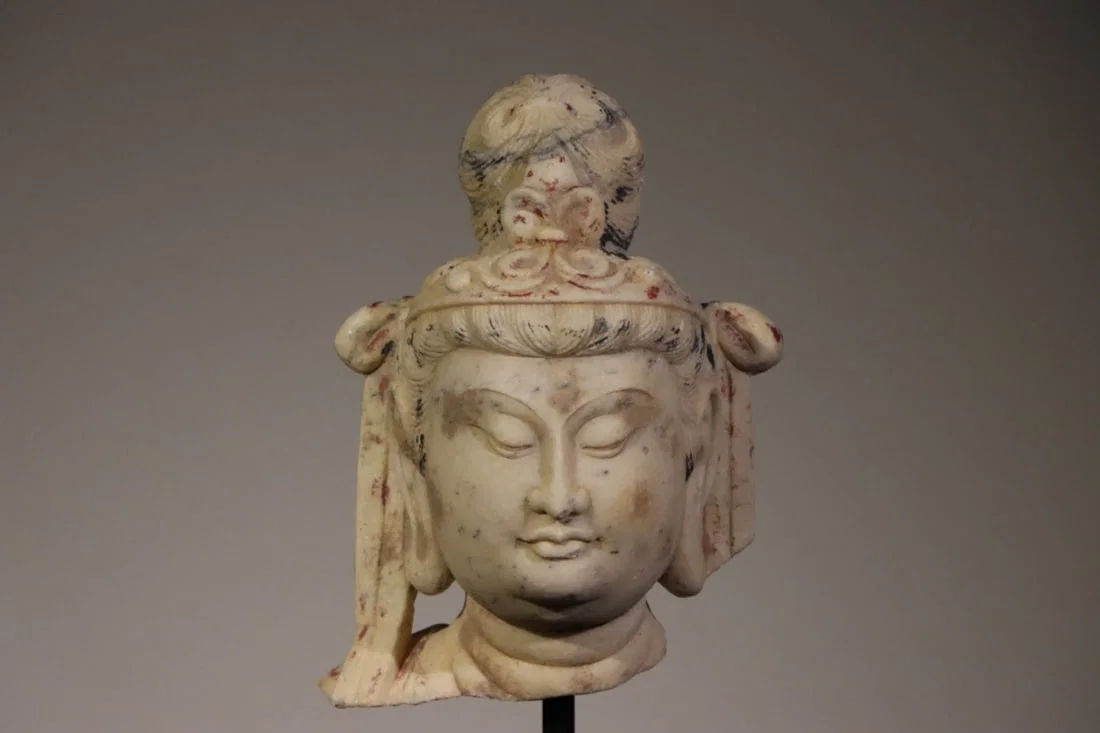 A FINE POLYCHROMED WHITE MARBLE HEAD OF GUANYIN, TANG DYNASTY, 7TH–8TH CENTURY AD