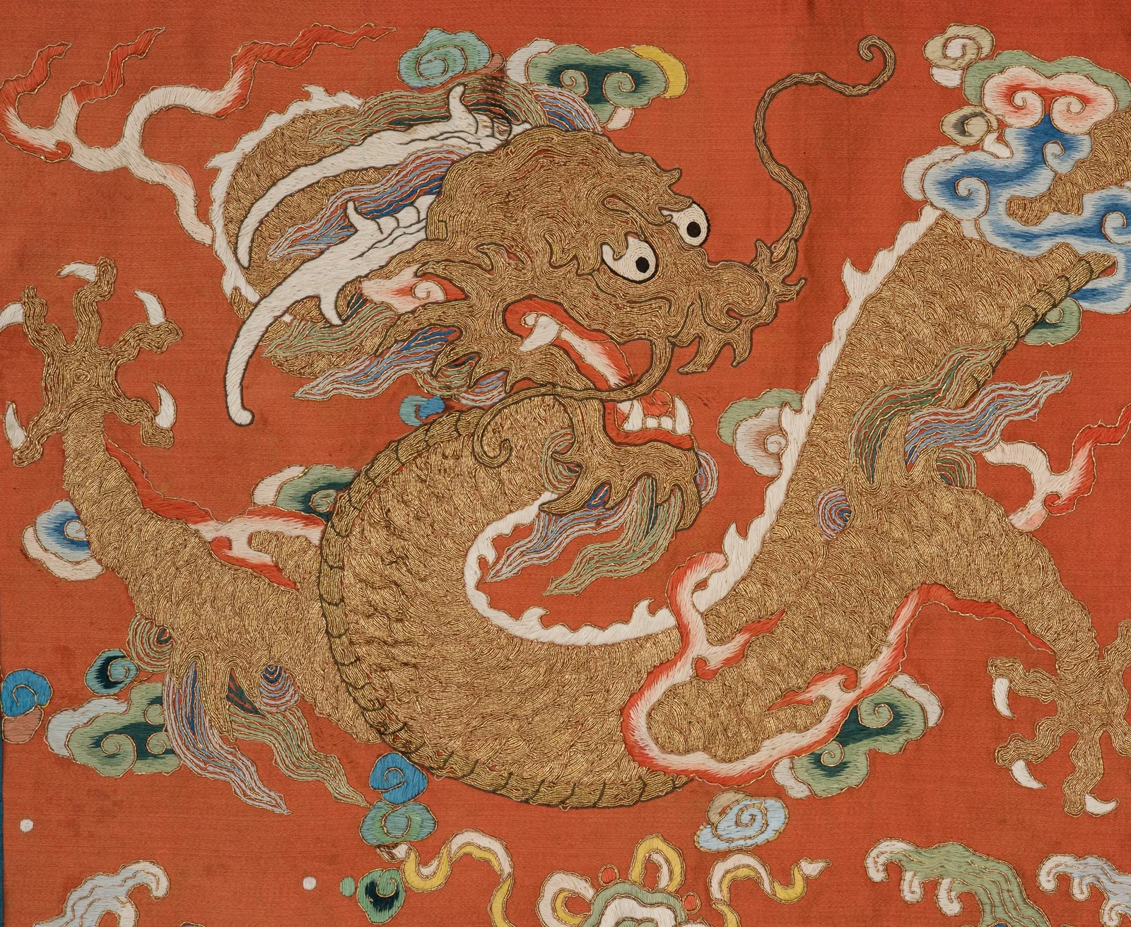 A FINELY EMBROIDERED 'DRAGON' APRICOT SILK PANEL, LATE 18TH TO EARLY 19TH CENTURY