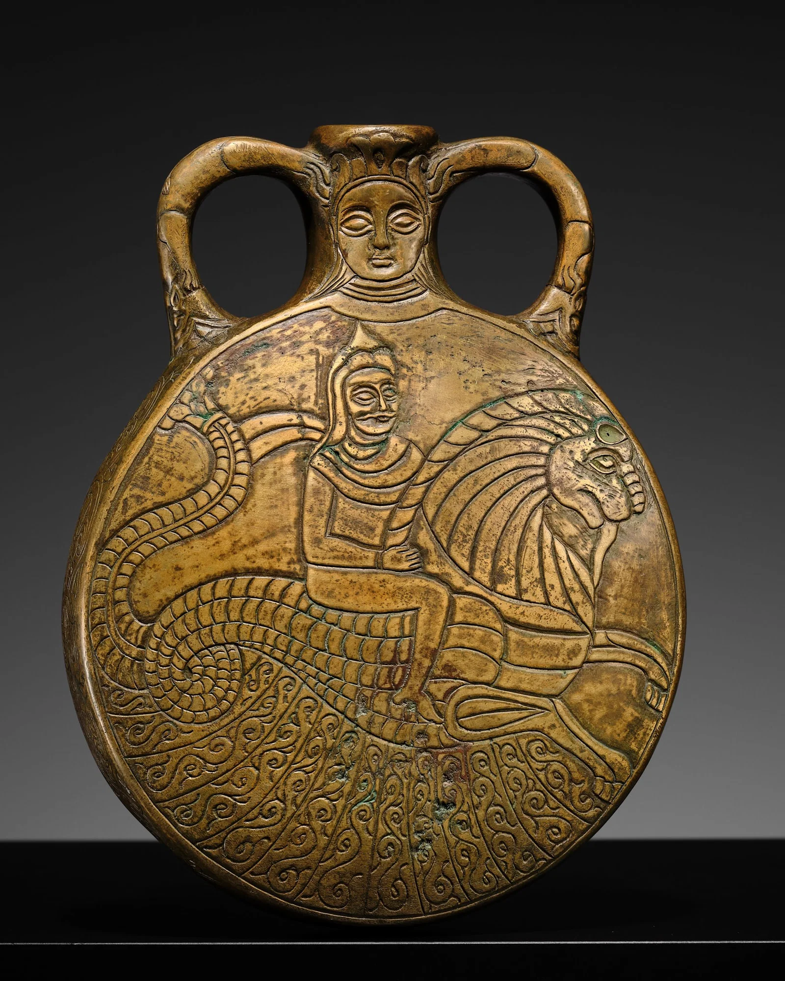 A FINELY ENGRAVED BRASS 'HERO ON MYTHICAL BEAST' PILGRIM FLASK, SASANIAN EMPIRE