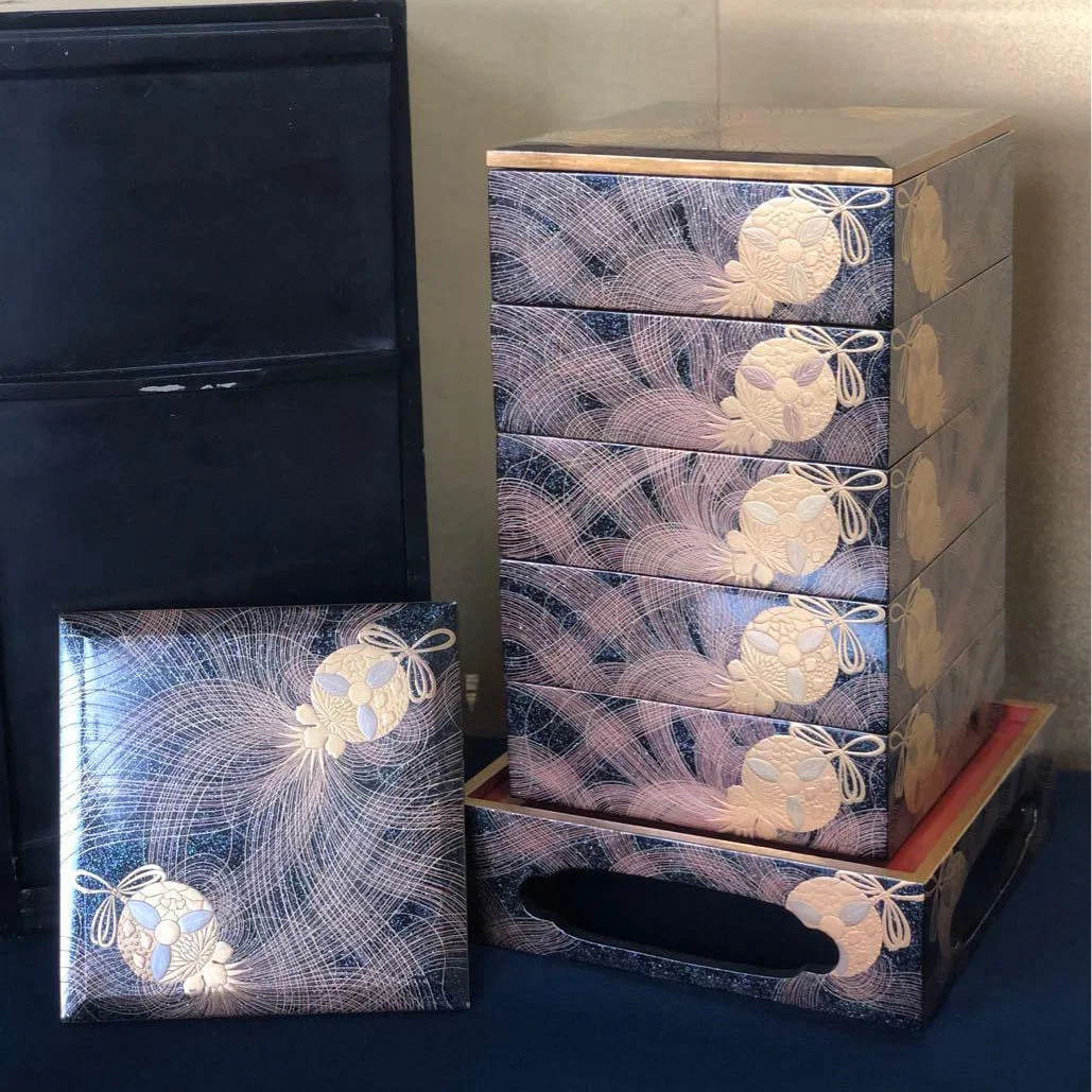 A five-tiered bento box with pear skin lacquer, featuring black and vermilion interiors.