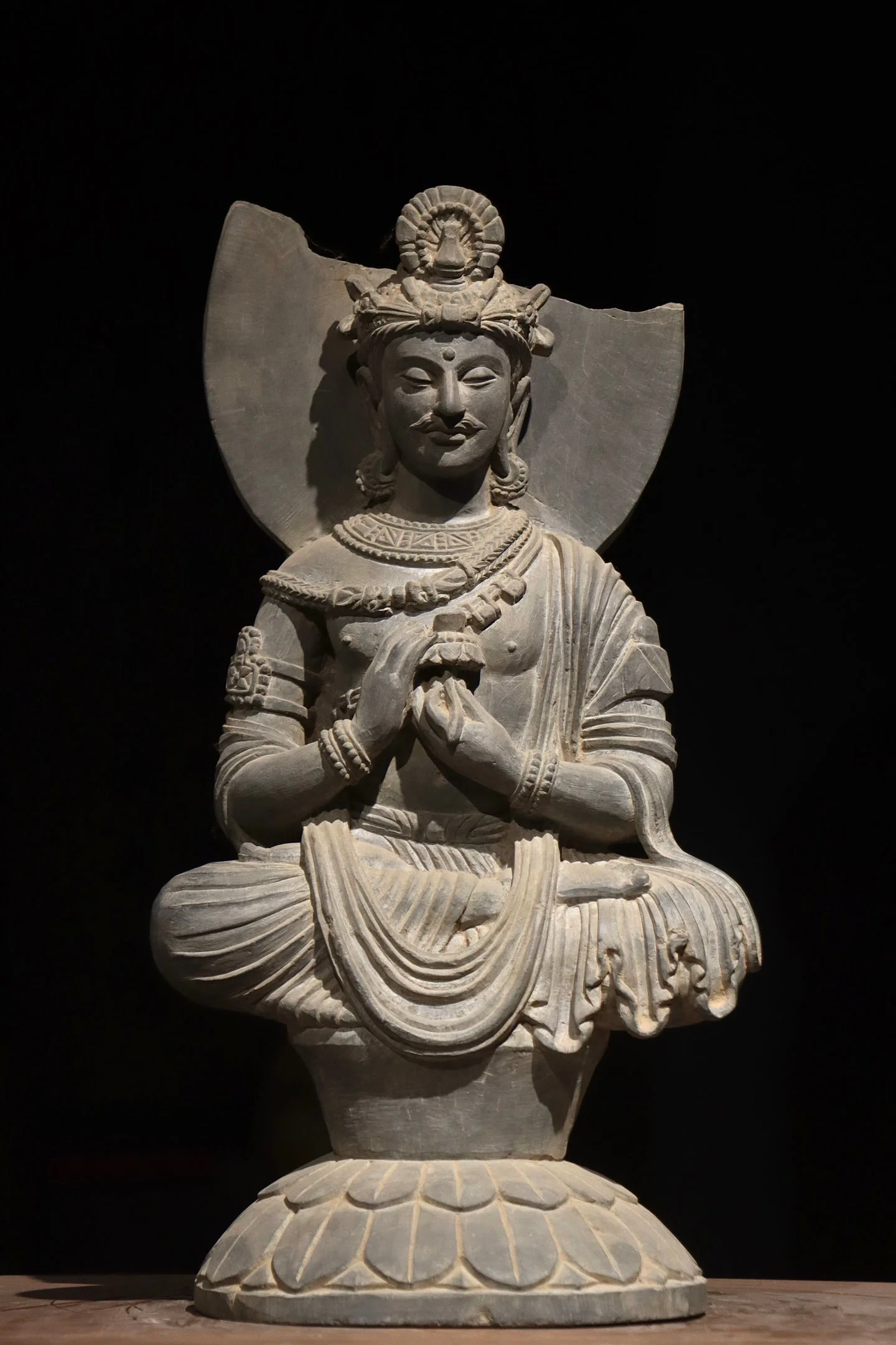 A Gandhara-style stone-carved seated Buddha statue