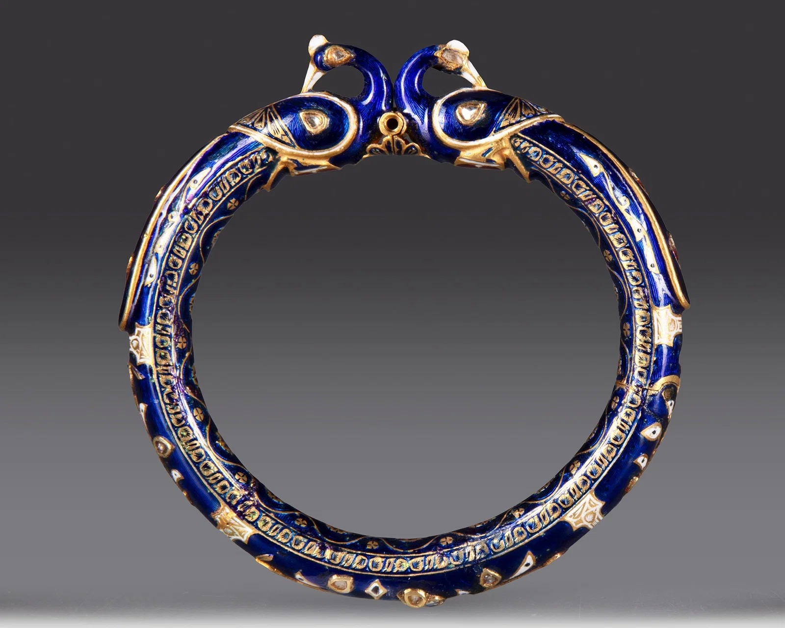 A GEM-SET ENAMELLED GOLD BANGLE, (KADA) NORTH INDIA, 19TH CENTURY