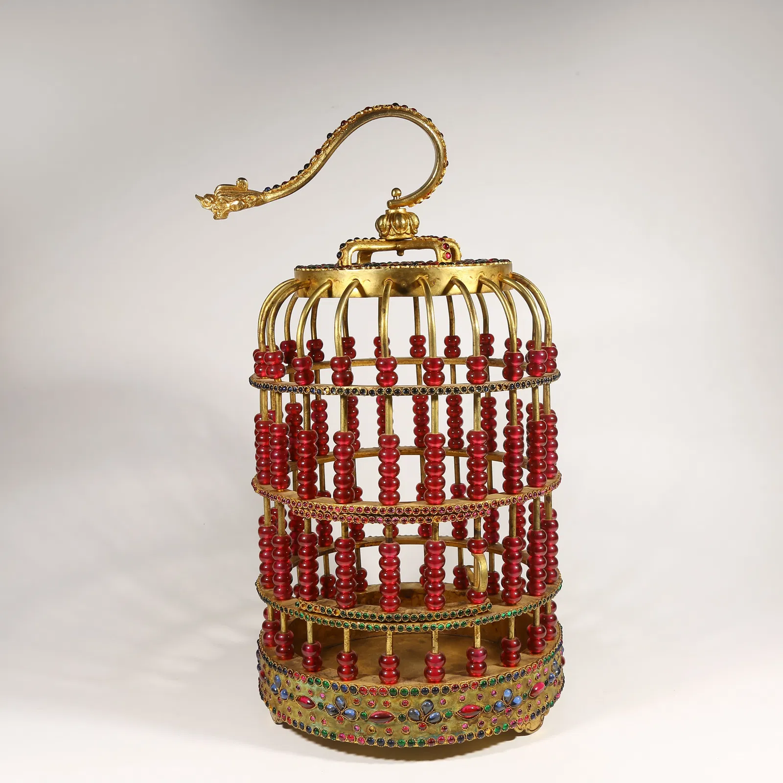 A GILDED BRONZE BIRDCAGE INLAID WITH GEMSTONES