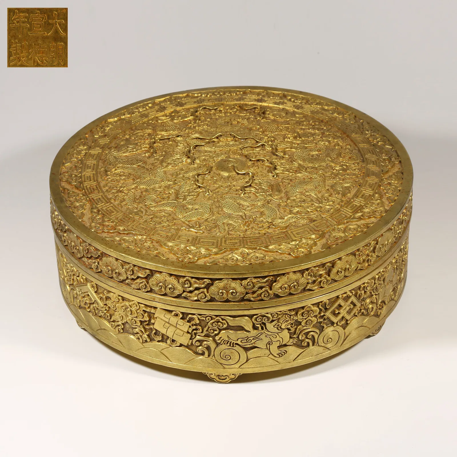 A GILDED BRONZE COVERED BOX WITH CLOUD AND DRAGON PATTERN
