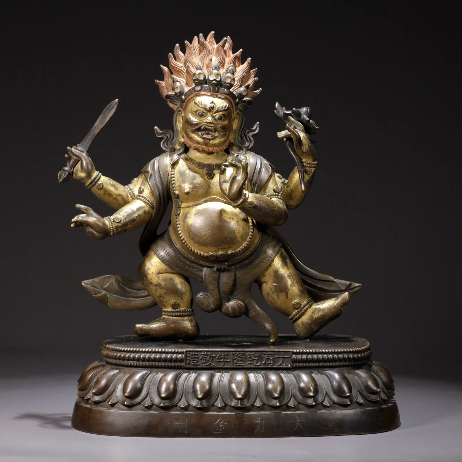 A GILDED BRONZE FOUR-ARMED MAHAKALA STATUE