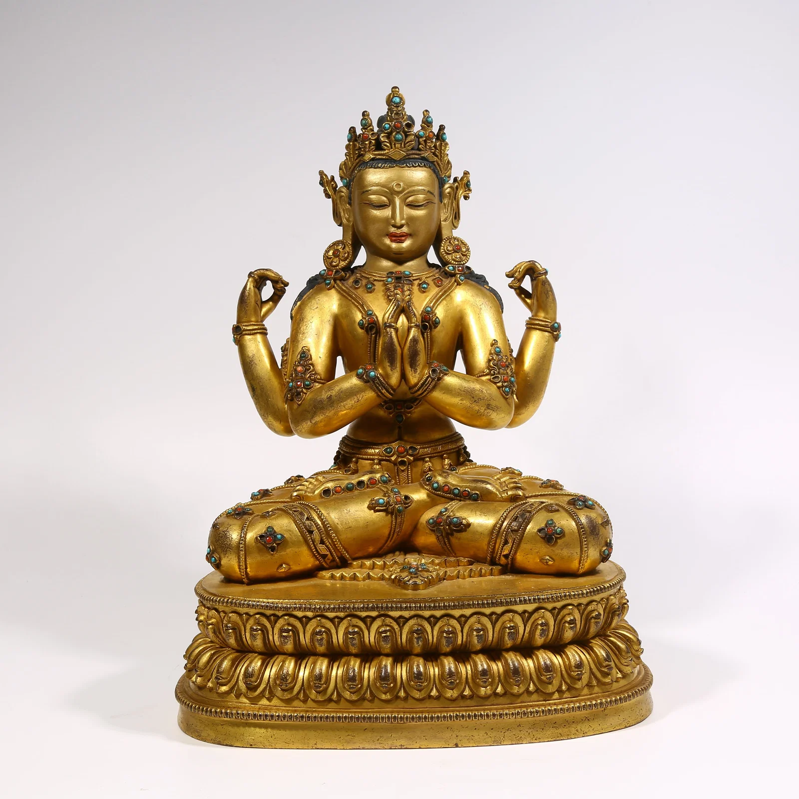 A GILDED BRONZE INLAID GEM FOUR-ARMED AVALOKITESHVARA STATUE