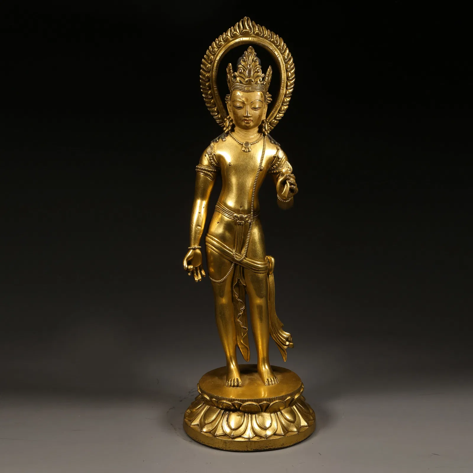 A GILDED BRONZE STANDING BODHISATTVA