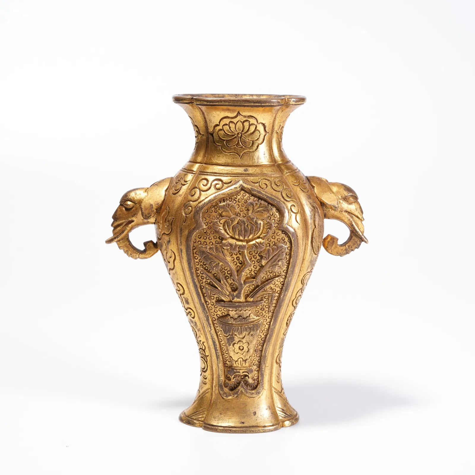 A GILDED BRONZE VASE WITH FLOWER PATTERN AND DOUBLE ELEPHANT HANDLES
