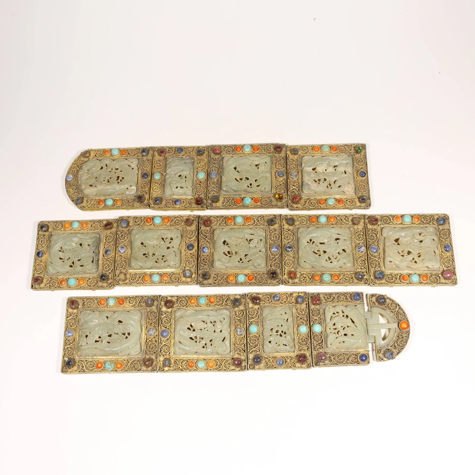 A GILDED SILVER FILIGREE BELT BUCKLE SET INLAID WITH GEMSTONES AND HETIAN JADE