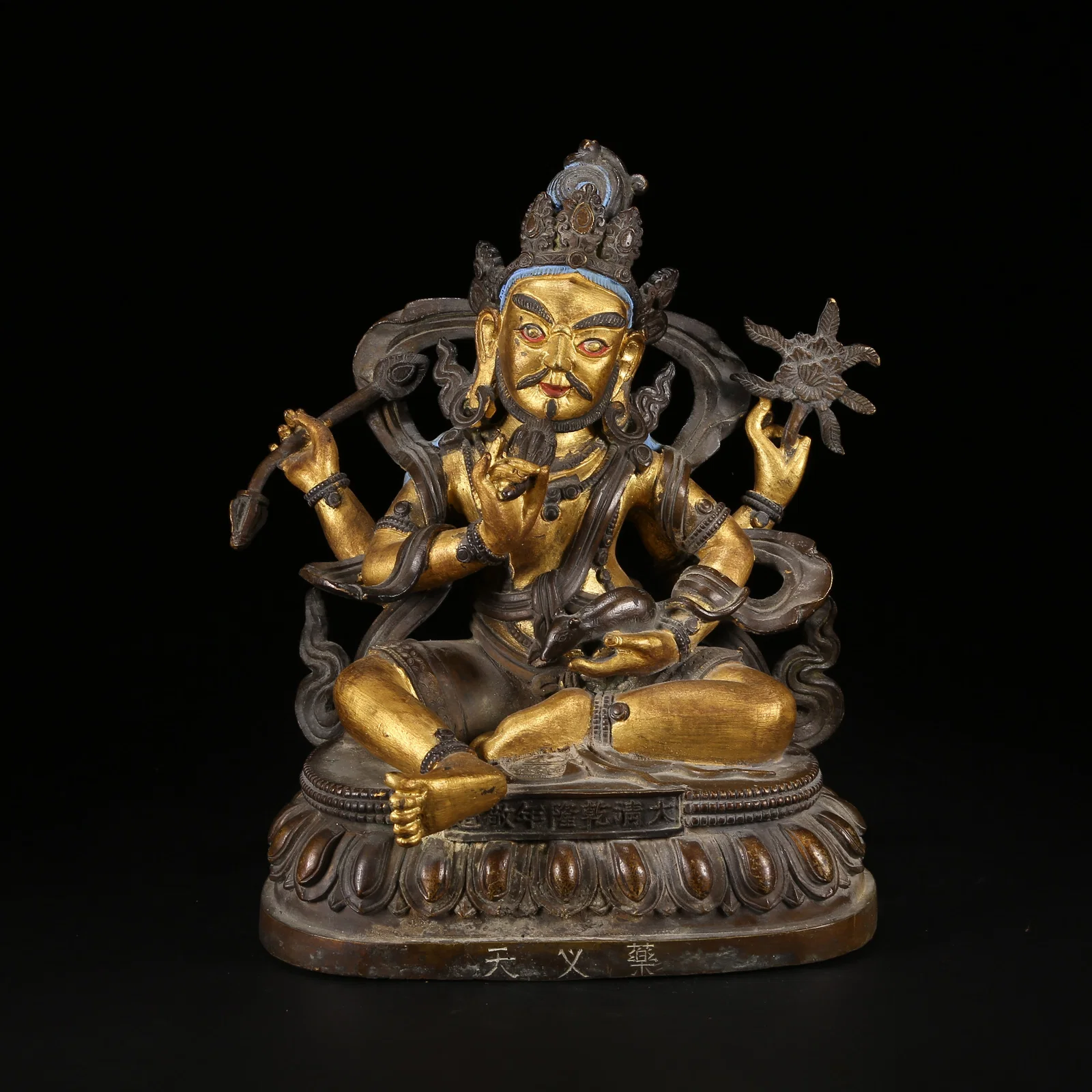 A GILT AND BRONZE ALLOY SIX-TIERED BUDDHIST TOWER STYLE YAKSHA GOD OF WEALTH STATUE