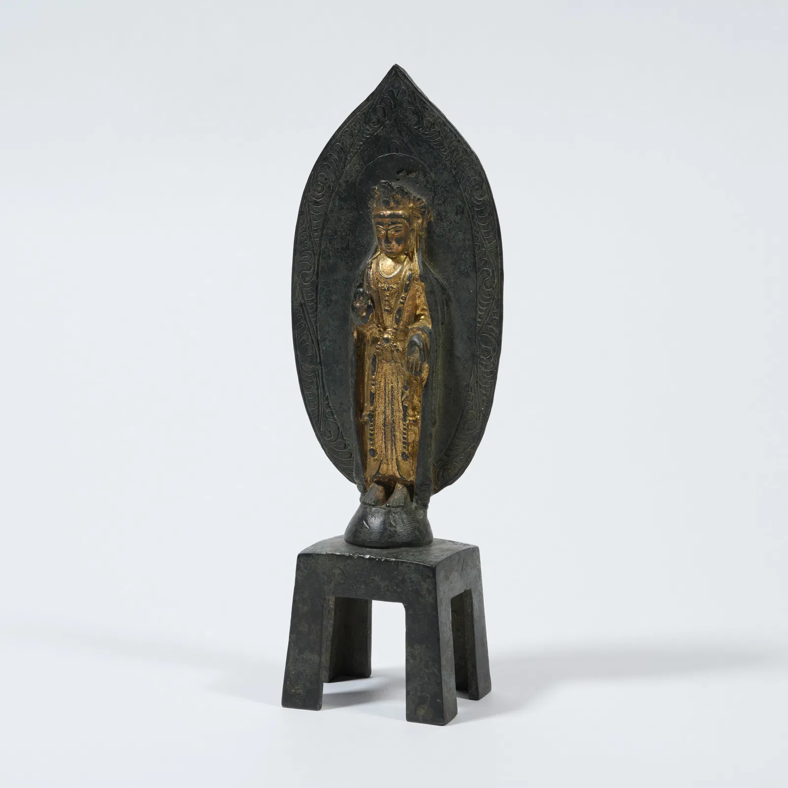 A GILT-BRONZE BENCH-SEATED BUDDHA FIGURE