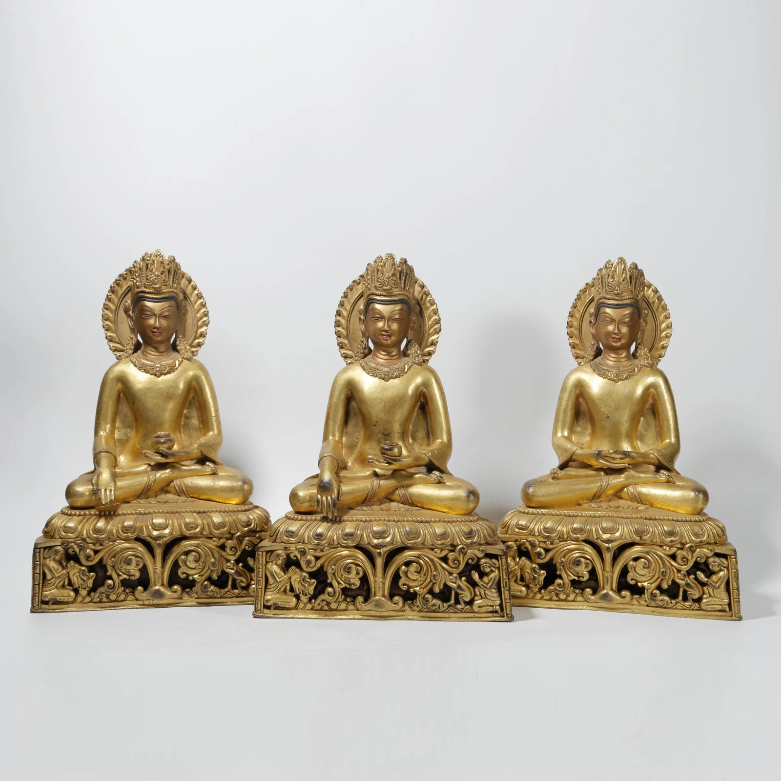 A GILT BRONZE BUDDHA STATUE SET