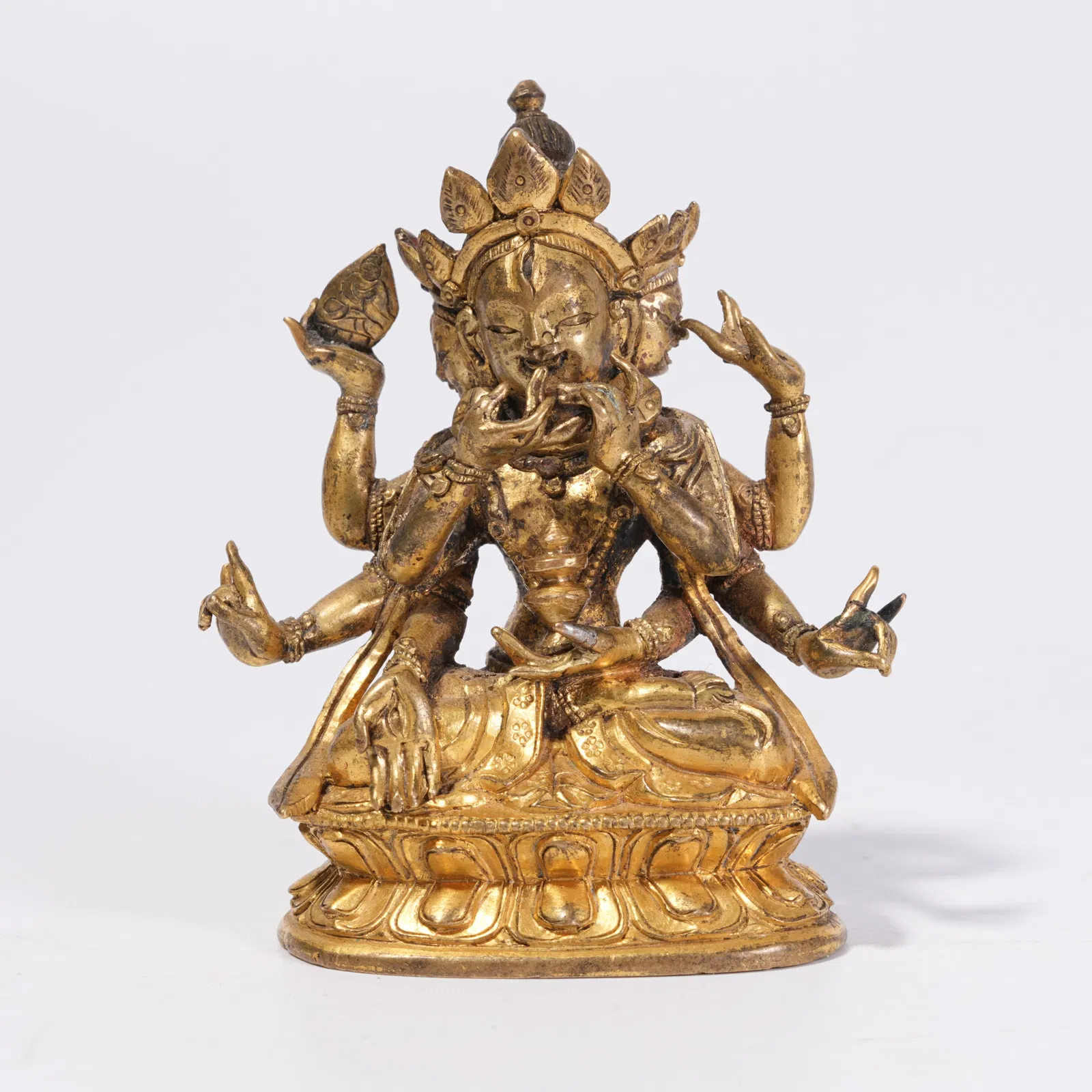 A GILT BRONZE EIGHT-ARMED GODDESS STATUE