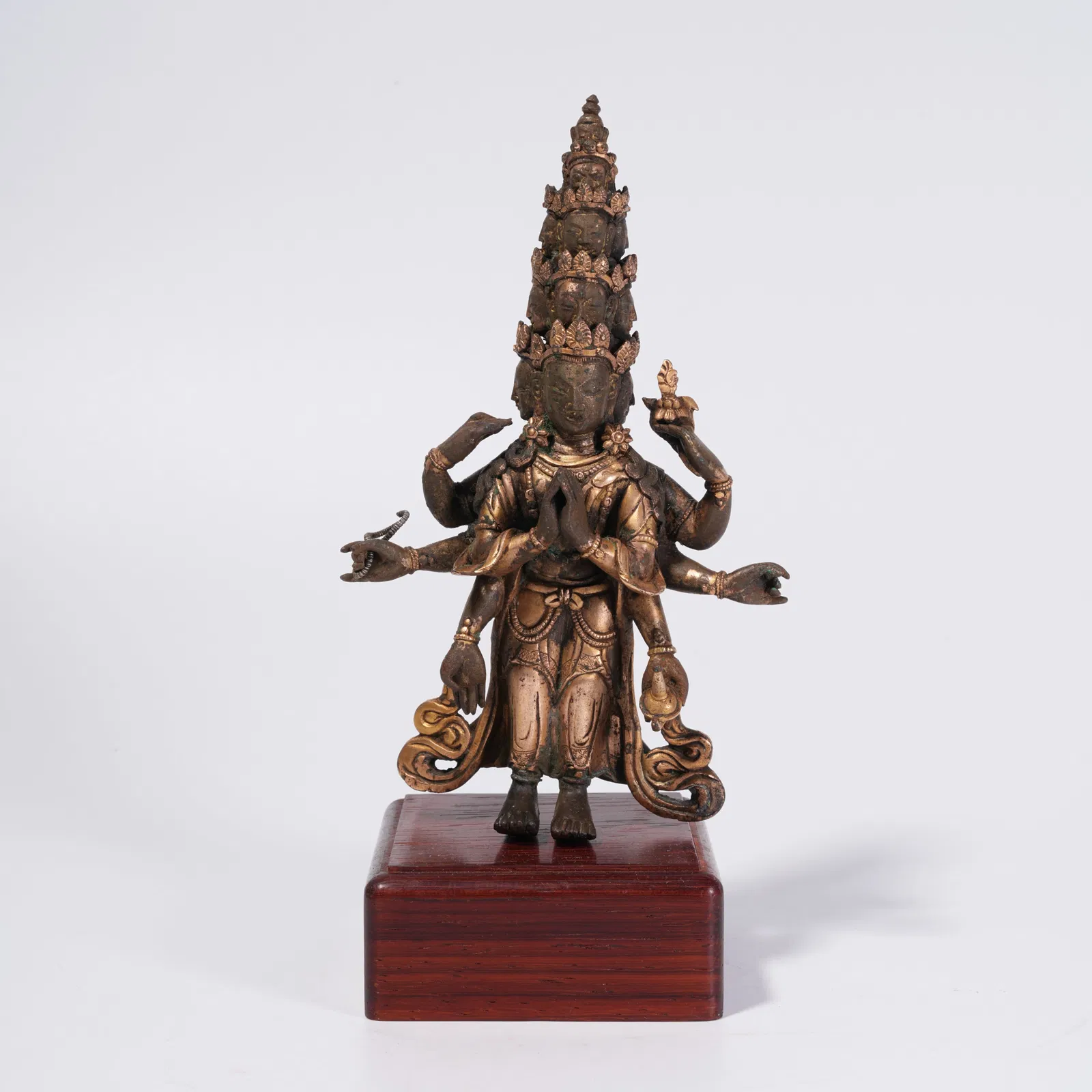 A GILT BRONZE ELEVEN-FACED AVALOKITESHVARA STATUE