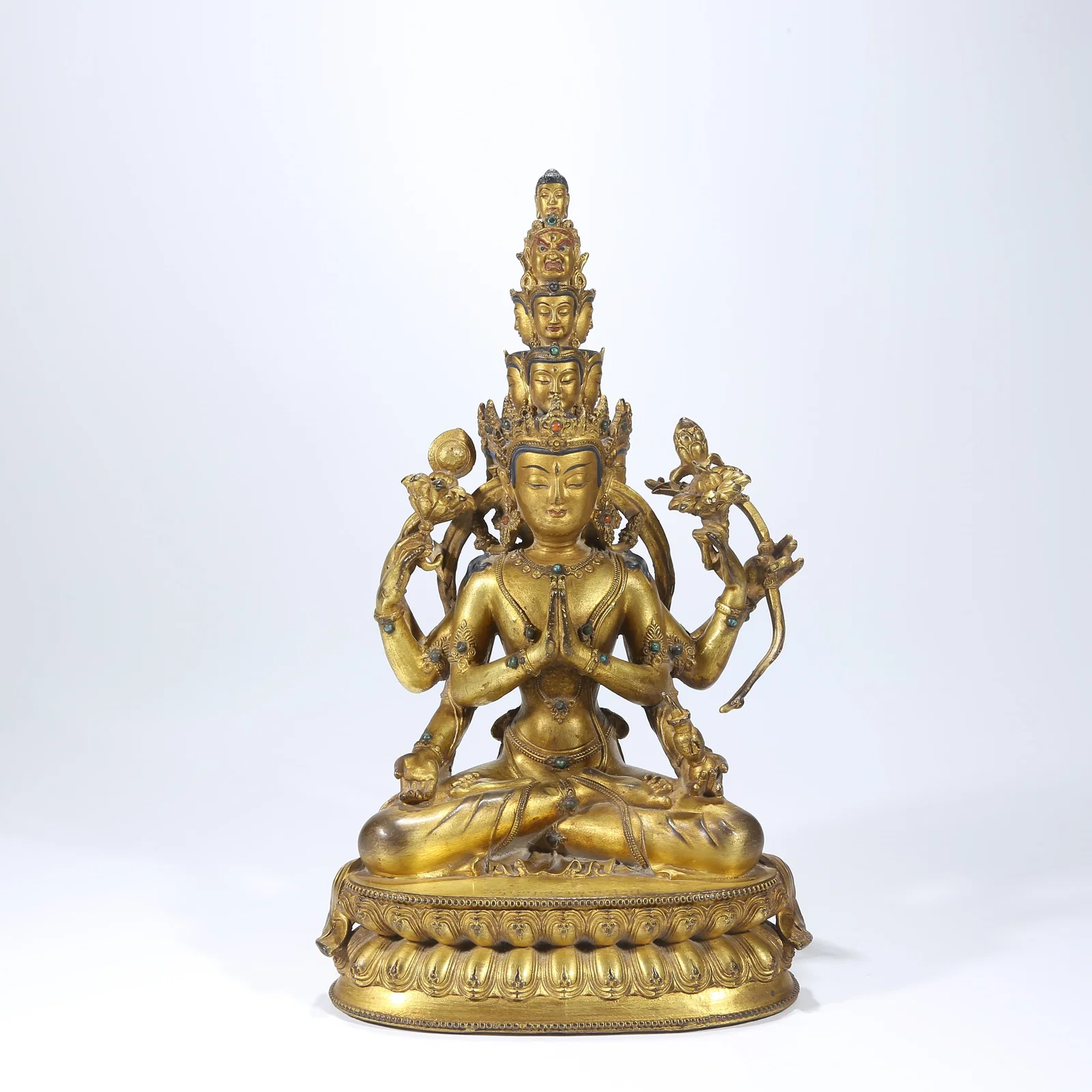 A GILT BRONZE ELEVEN-FACED GUANYIN STATUE INLAID WITH GEMSTONES