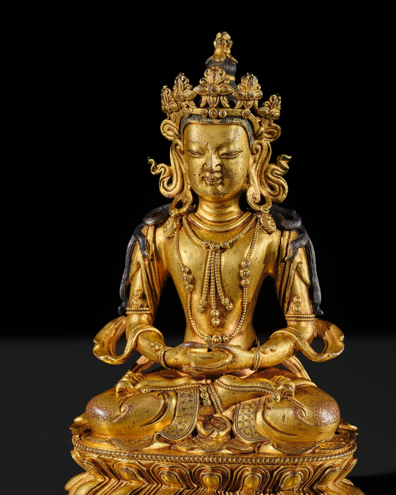 A GILT-BRONZE FIGURE OF AMITAYUS, TIBETAN-CHINESE, 18TH CENTURY