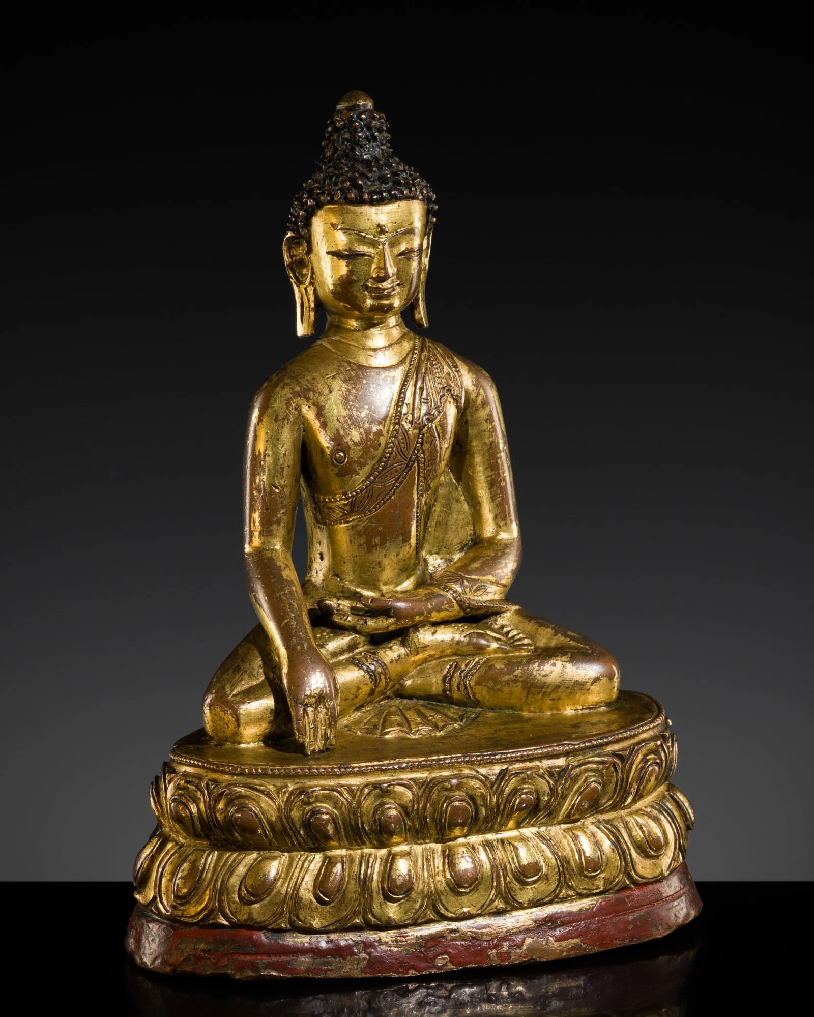 A GILT-BRONZE FIGURE OF BUDDHA SHAKYAMUNI, TIBET, 15TH CENTURY