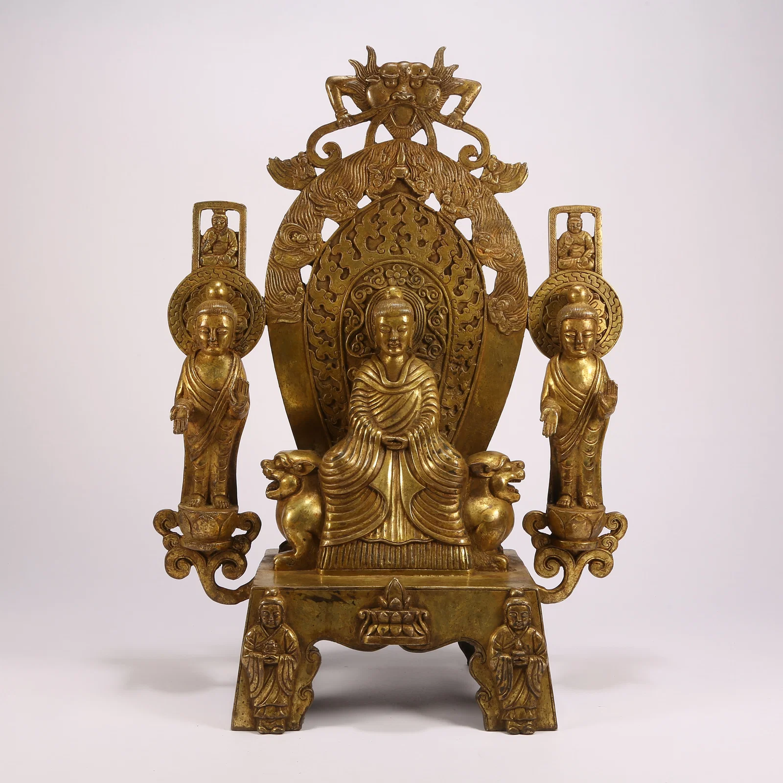 A GILT BRONZE FIGURE OF BUDDHA WITH TWO ATTENDANT FIGURES