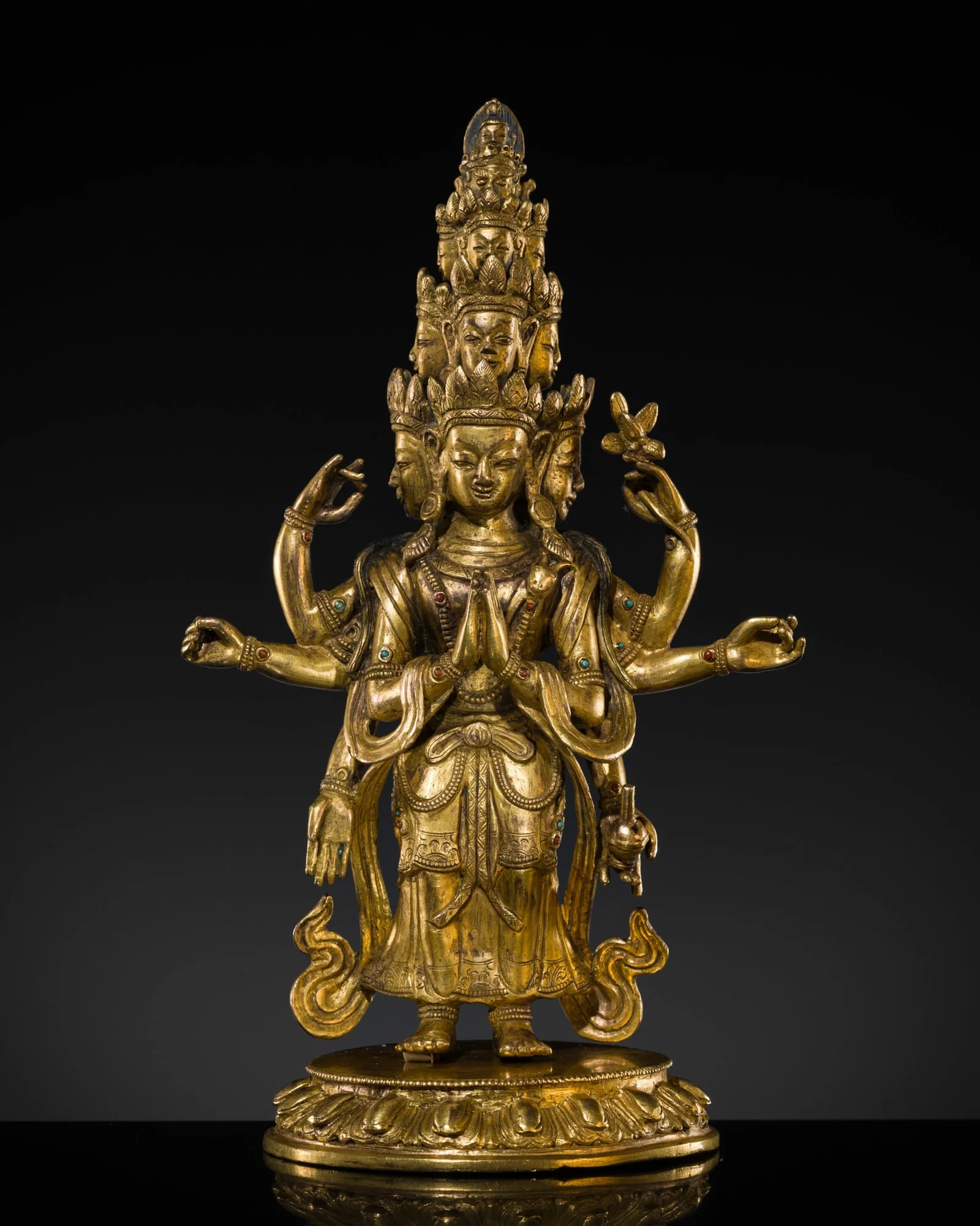 A GILT-BRONZE FIGURE OF EKADASHAMUKHA AVALOKITESHVARA, TIBETAN-CHINESE, 18TH CENTURY