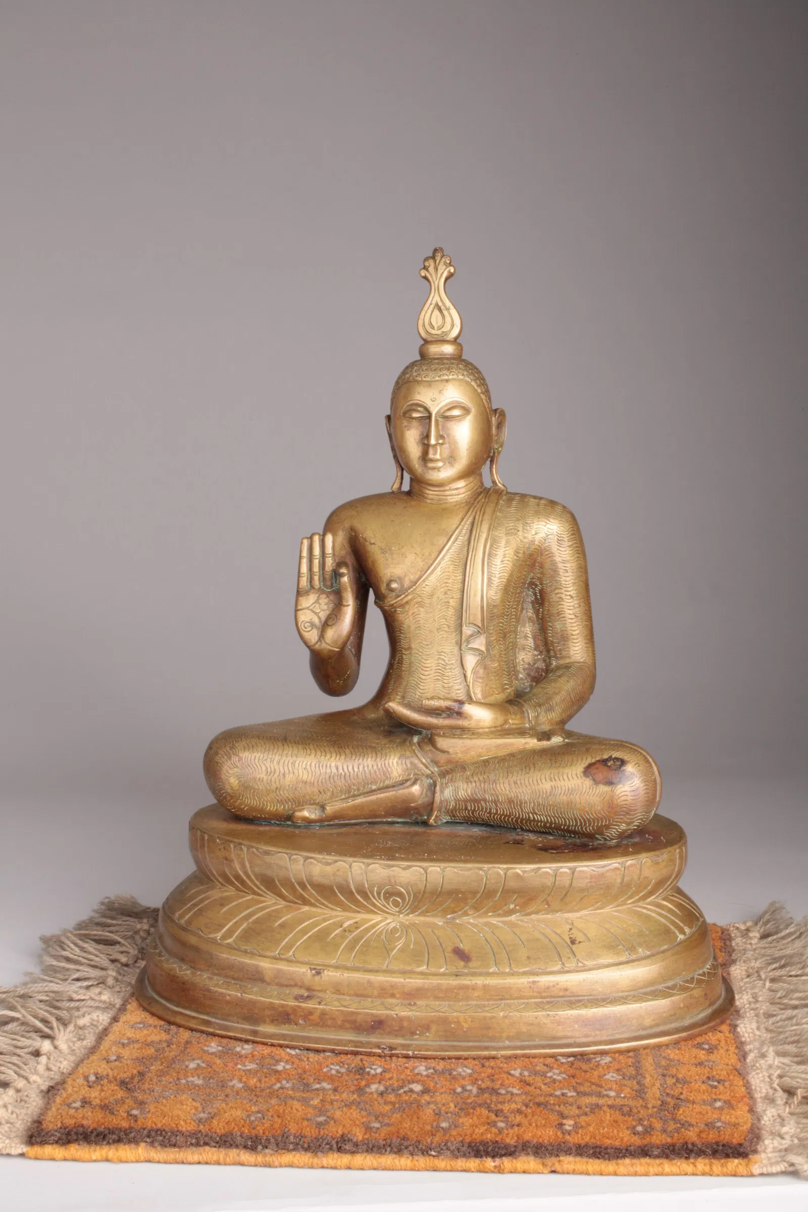 A Gilt Bronze Figure of Seated Shakyamuni Buddha, Sri Lanka, Kandy Period
