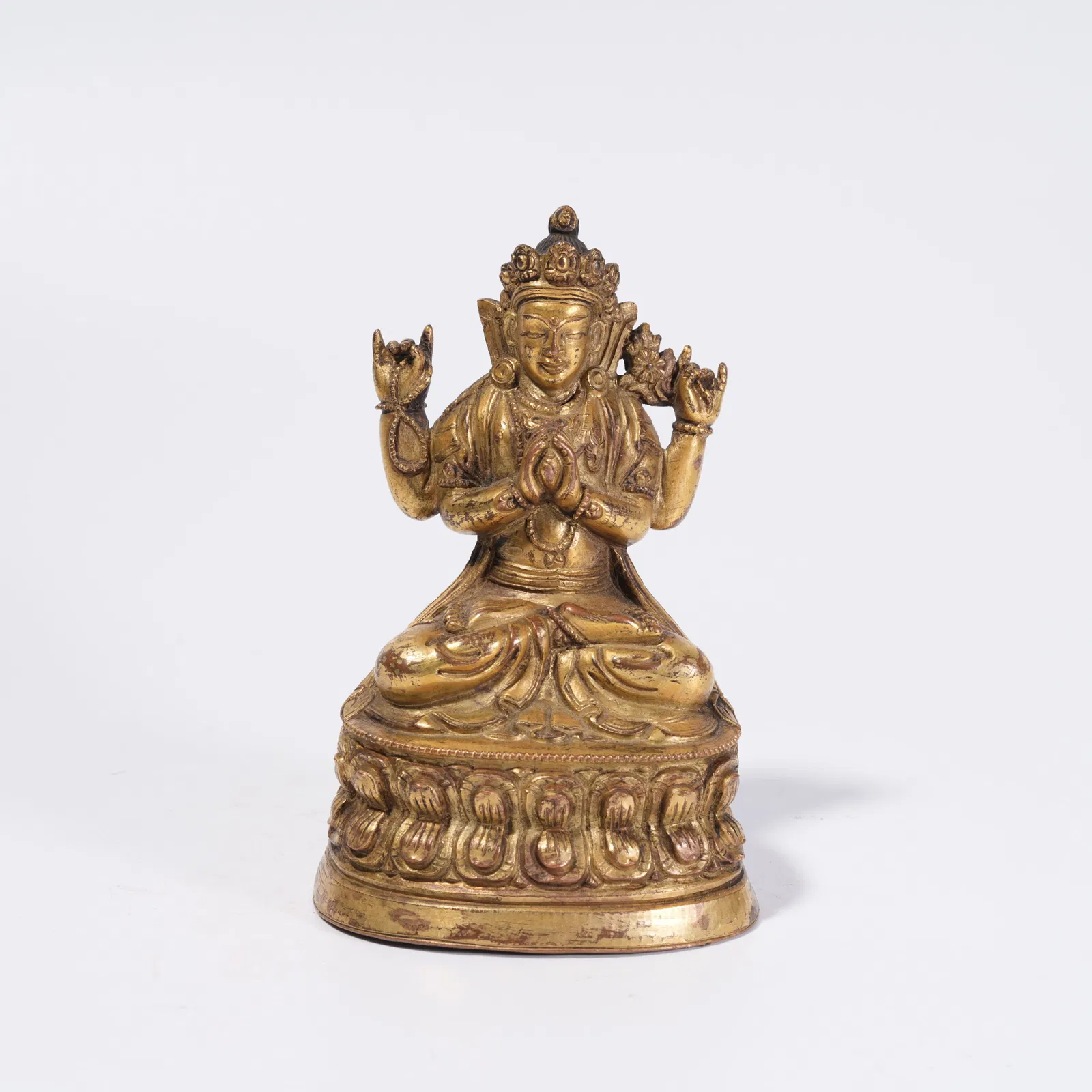 A GILT BRONZE FOUR-ARMED AVALOKITESHVARA STATUE