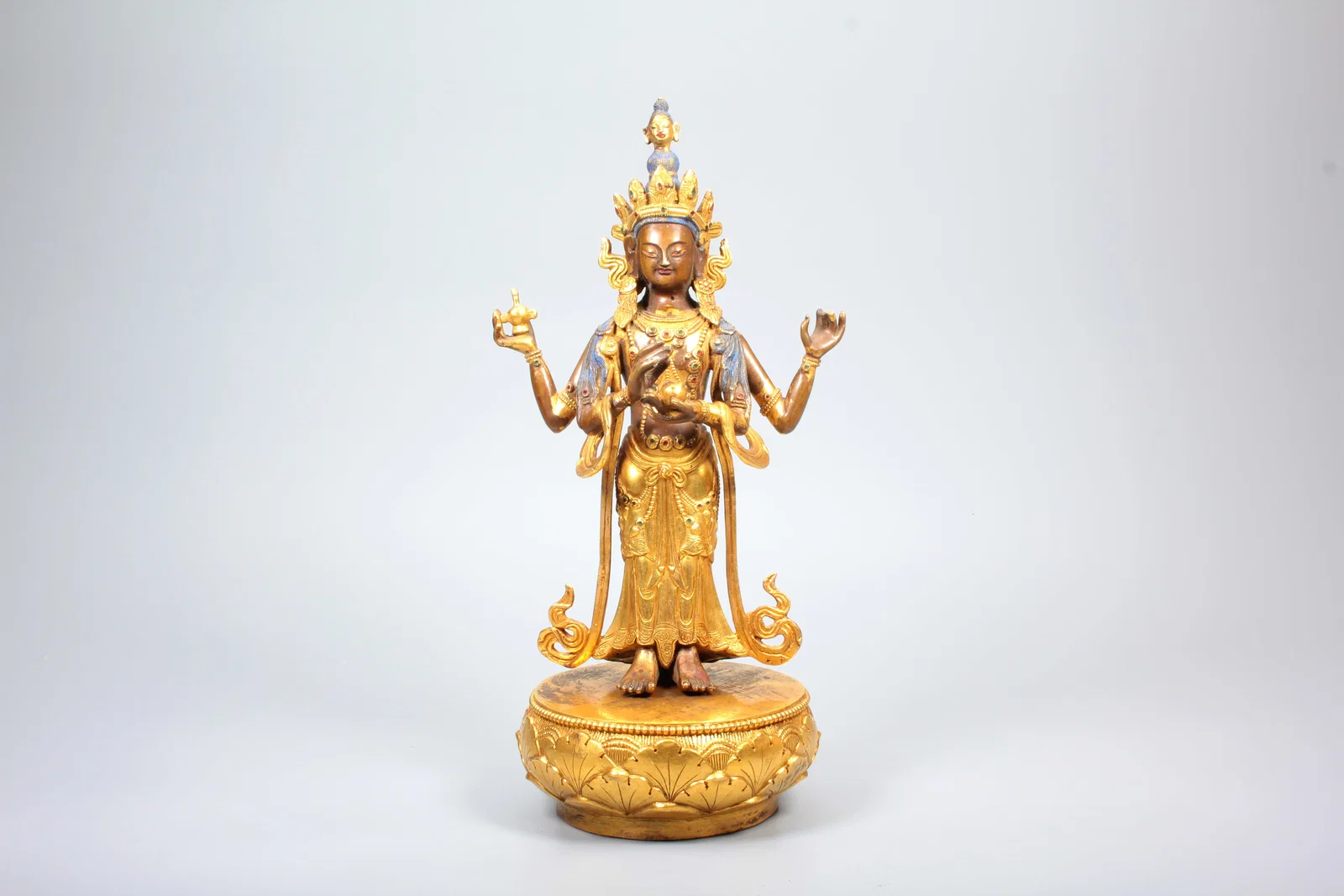 A GILT-BRONZE FOUR-ARMED AVALOKITESVARA STANDING STATUE ON LOTUS BASE