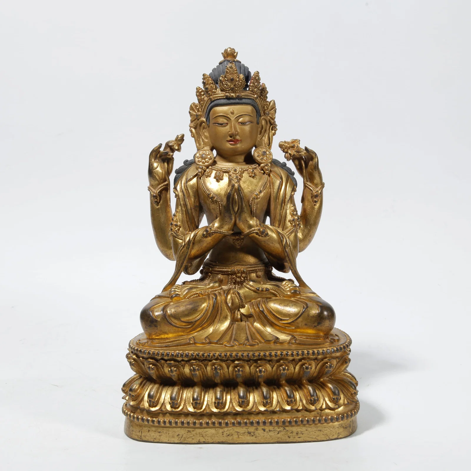 A GILT BRONZE FOUR-ARMED GUANYIN STATUE
