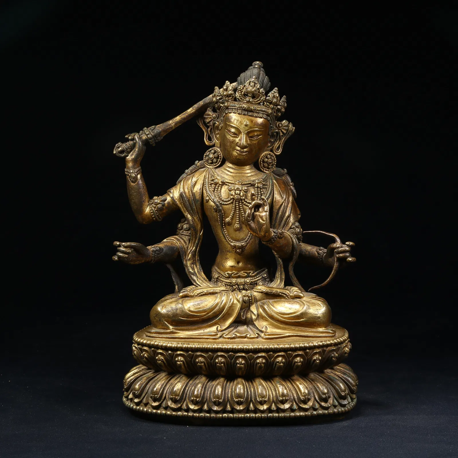 A GILT BRONZE FOUR-ARMED MANJUSHRI BODHISATTVA STATUE