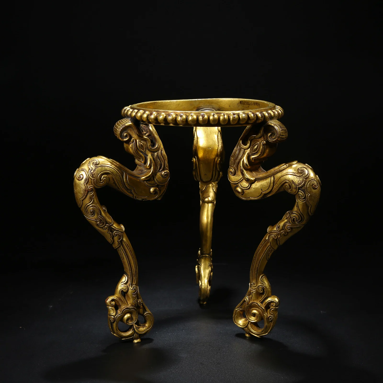 A GILT BRONZE GABALA (SKULL CUP) BASE
