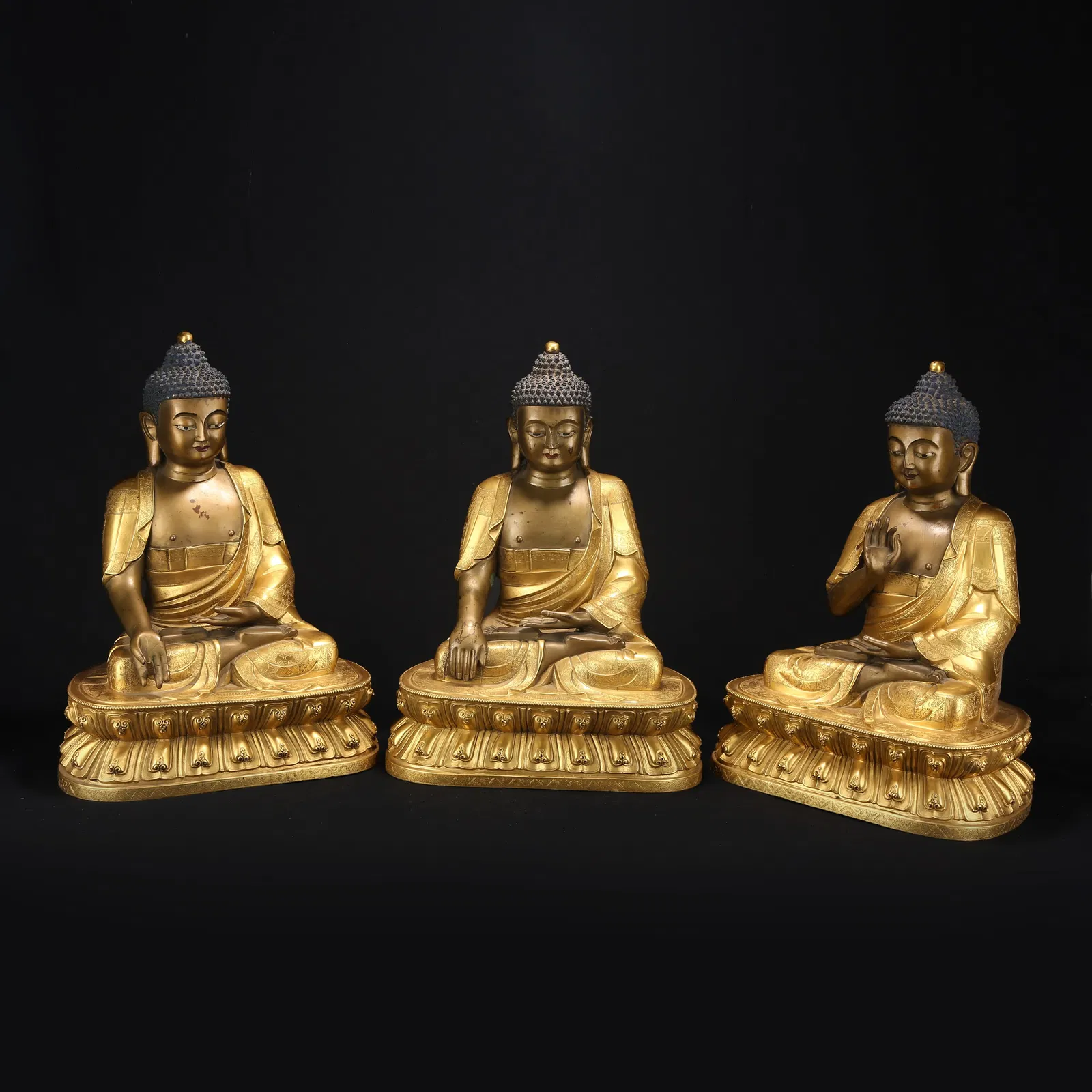 A GILT BRONZE GROUP OF THE THREE BUDDHAS (PAST, PRESENT, AND FUTURE)