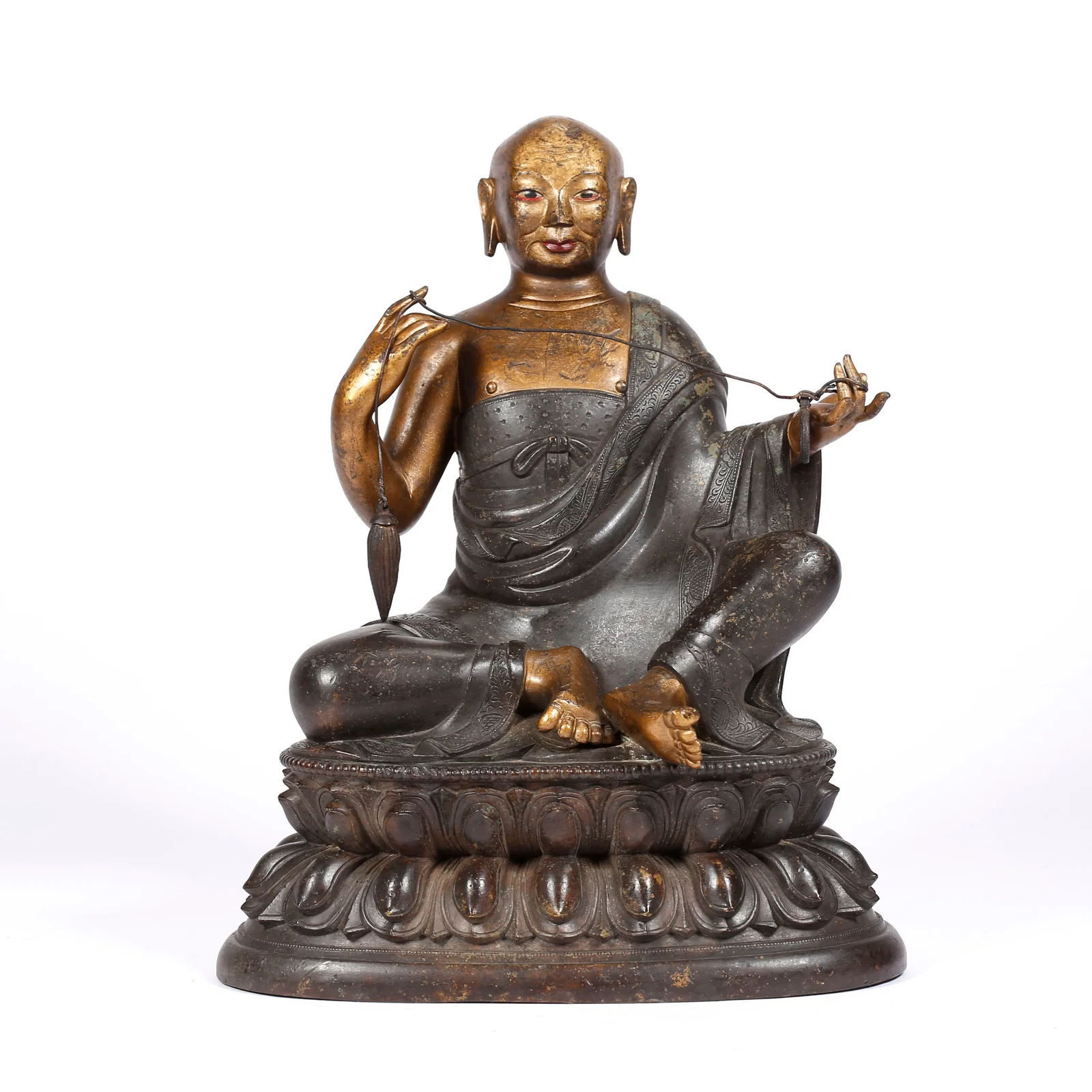 A GILT BRONZE LAMA STATUE