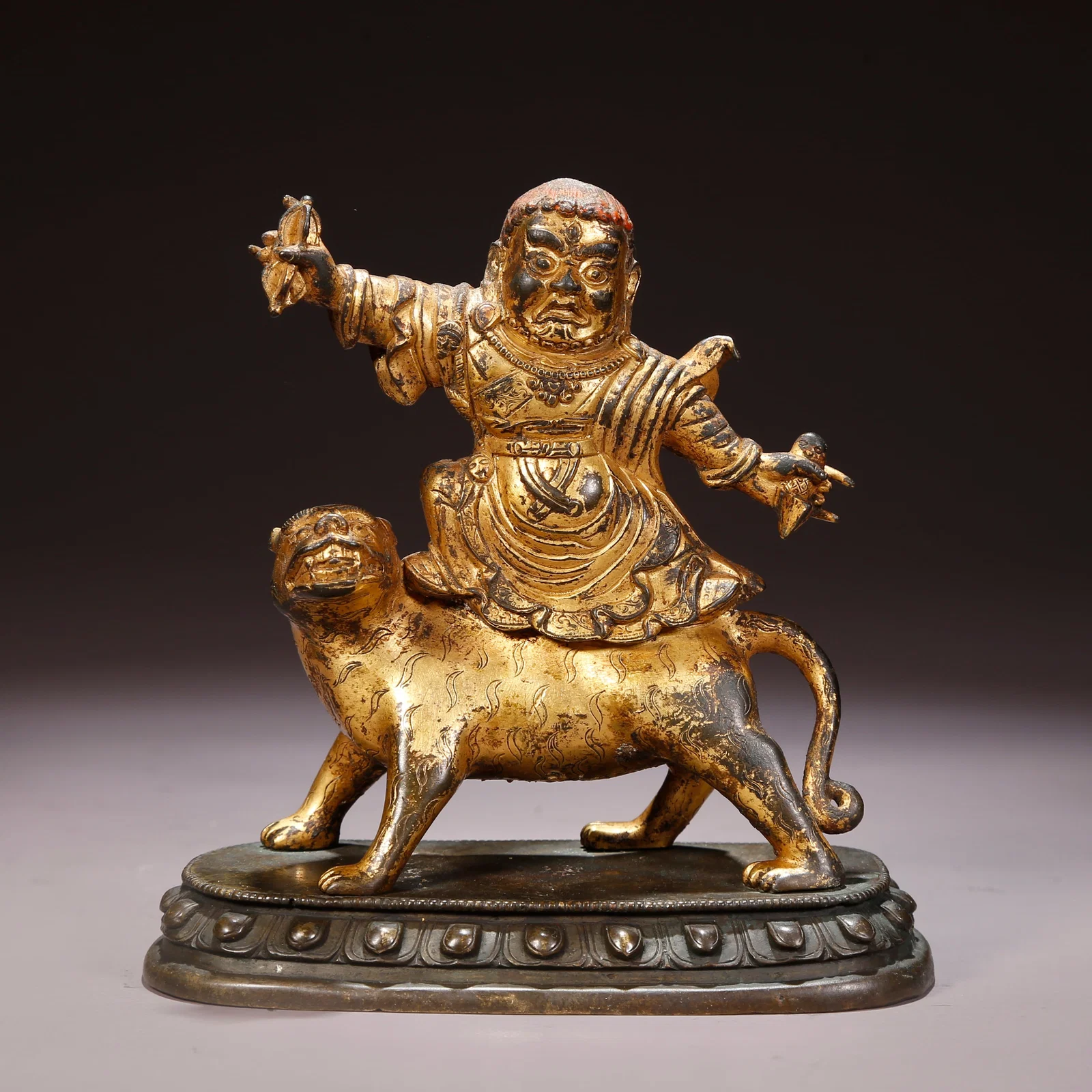 A GILT-BRONZE LION'S ROAR PADMASAMBHAVA FIGURE