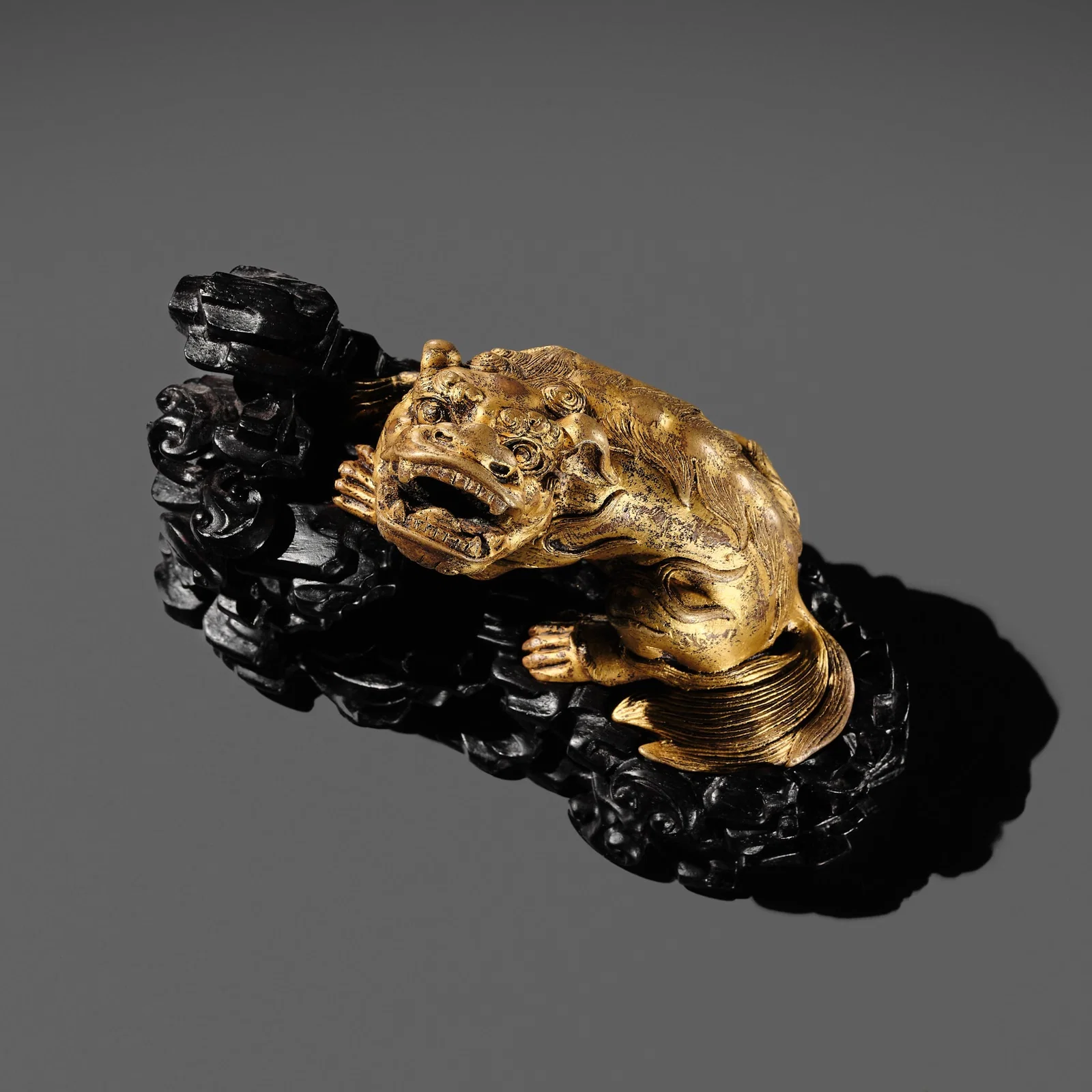 A GILT BRONZE 'LION' WEIGHT WITH A MATCHING ZITAN BASE, CHINA, 16TH-17TH CENTURY