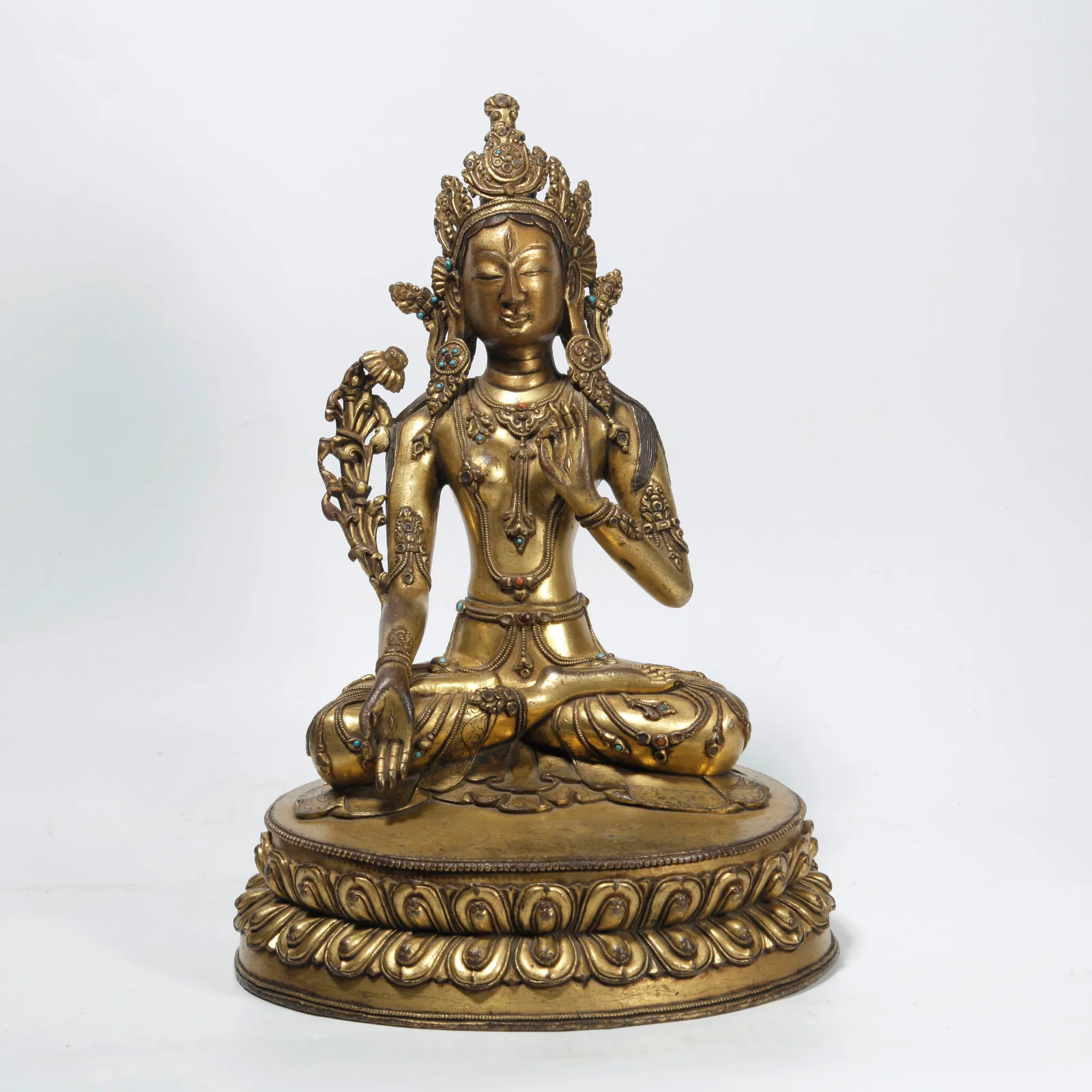 A GILT BRONZE LOTUS-HOLDING GUANYIN STATUE