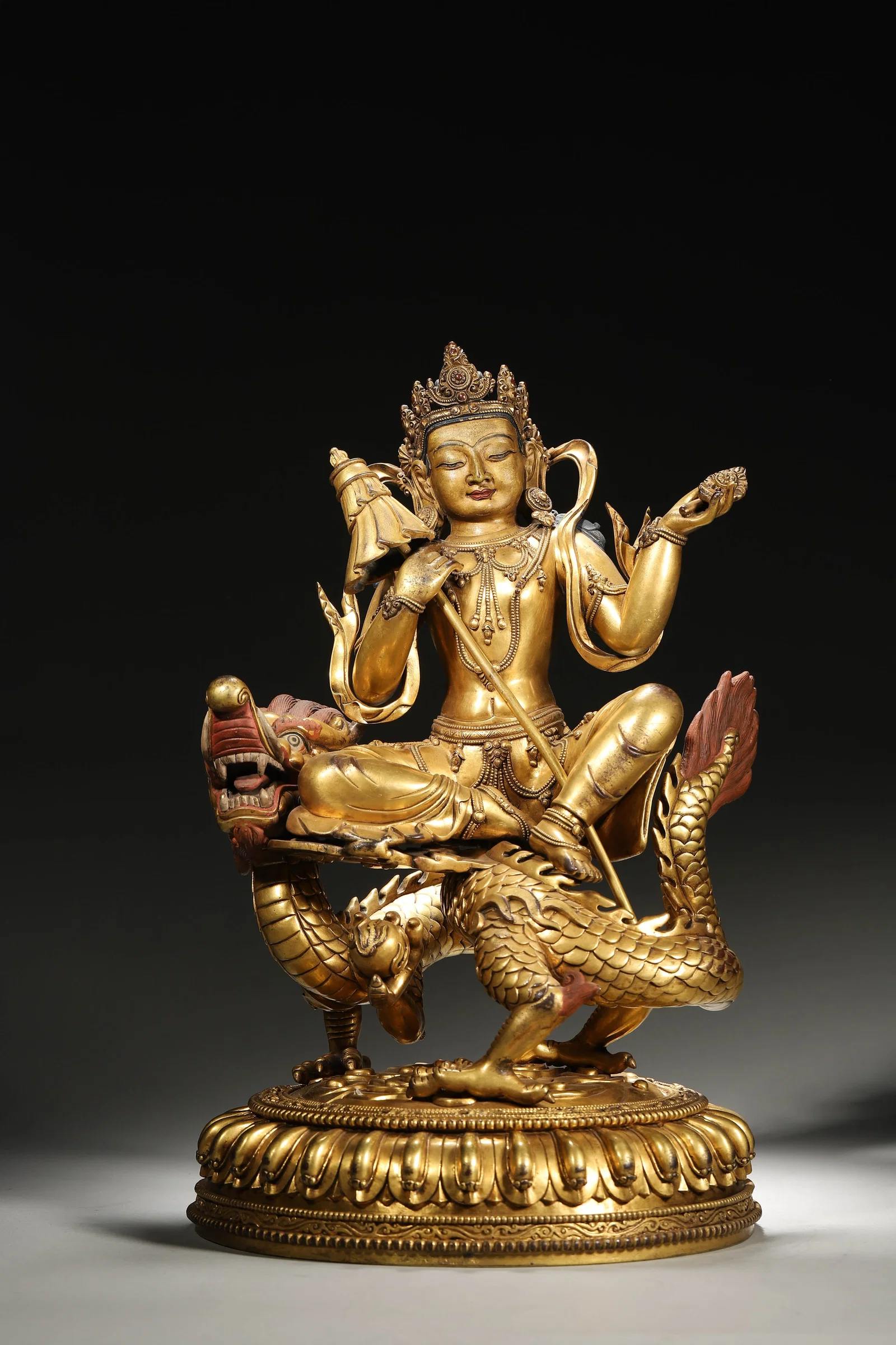 A GILT-BRONZE MANJUSHRI STATUE SEATED ON A DRAGON, QING DYNASTY