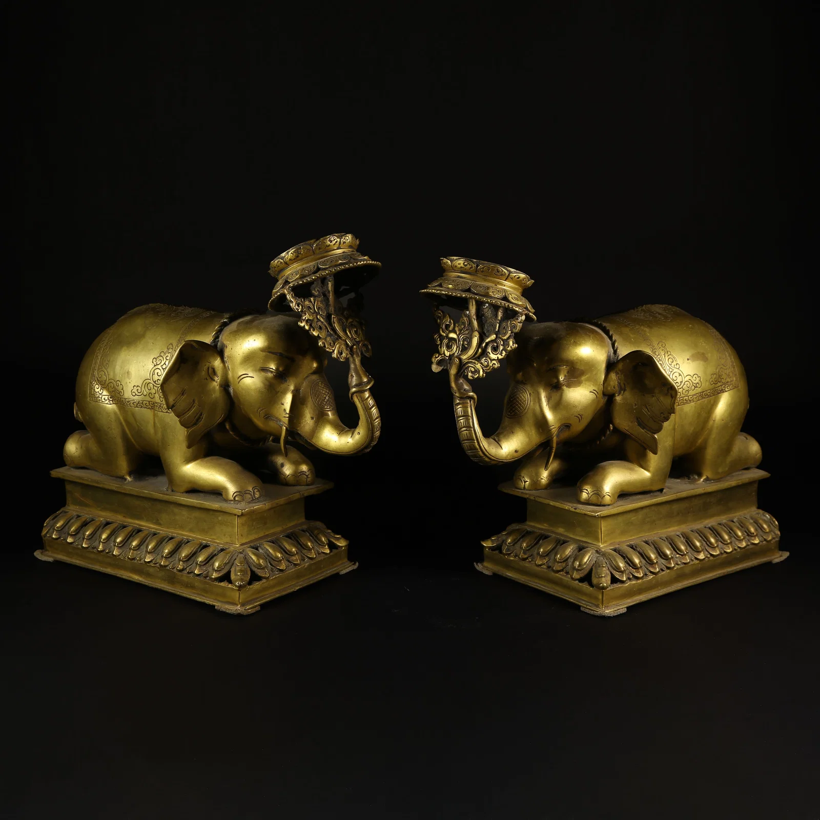 A GILT-BRONZE "PEACE AND PROSPERITY" ELEPHANT CANDLESTICK