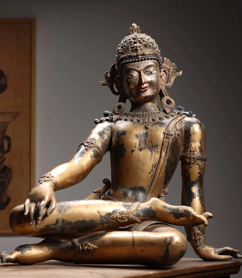 A GILT-BRONZE SEATED FIGURE OF GUANYIN (AVALOKITESHVARA), QING DYNASTY, TIBETAN STYLE