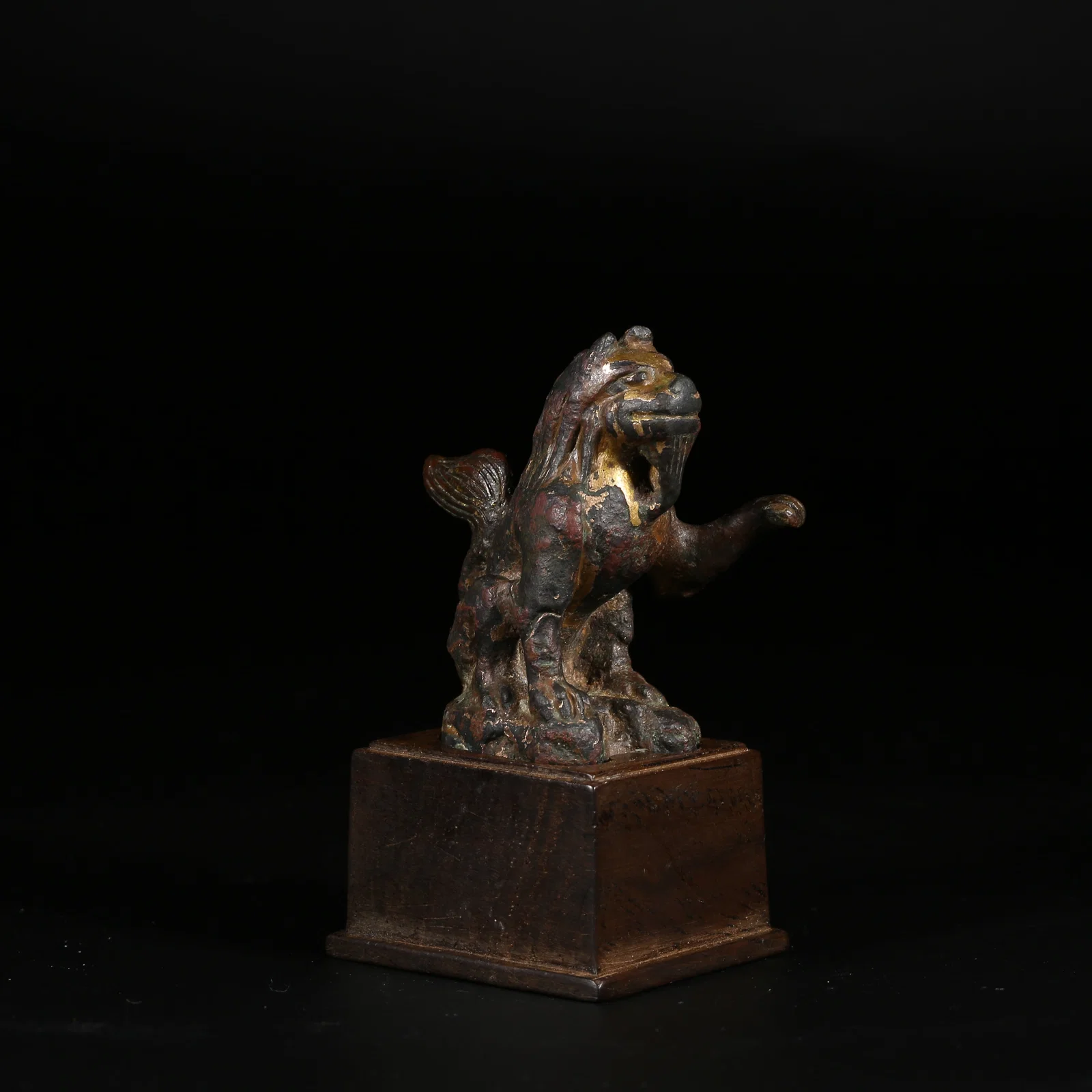 A GILT-BRONZE SEATED GUARDIAN LION